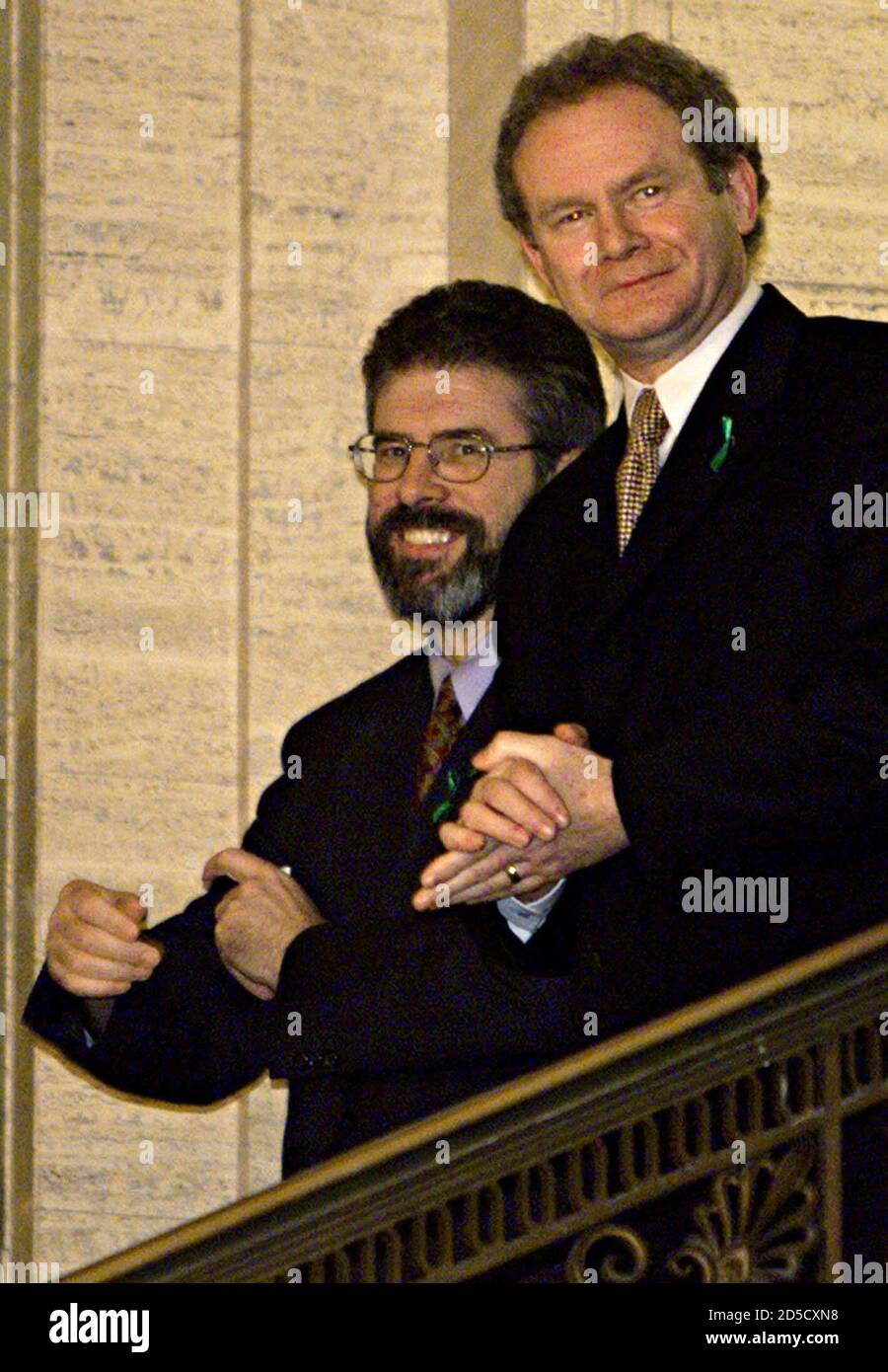 Sinn Fein Minister for Education Martin McGuinness (R) and leader Gerry Adams smile as they descend the stairs at Stormont Building, November 29. Protestant and Roman Catholic parties nominated ministers to a coalition government of pro-Irish Republicans and pro-British Unionists which will become fully operational on Thursday, when London will hand over power.  FP Stock Photo