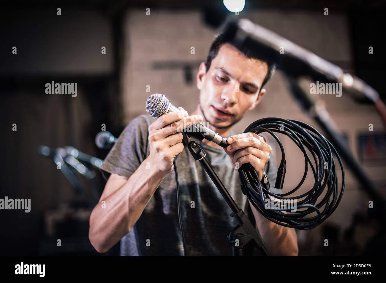 Theater audio technician adjusting an microphones on the scene