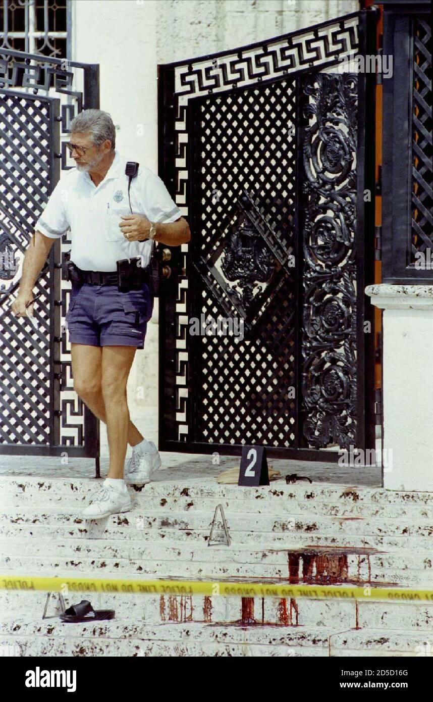 A Miami Beach police officer exits the home of fashion designer Gianni  Versace, 50, who was murdered in front of the residence earlier July 15.  Versace was shot twice in the head