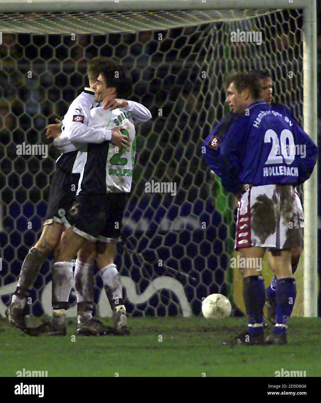 Bernd Hollerbach R Of Hamburger Sportverein Watches Sebescen Zoltan C Of Vfl Wolfsburg Hug His Team Mate Andrzej Juskowiak After Wolfsburg S Juergen Rische Scored Against Hamburger Sportverein Hsv During A German First