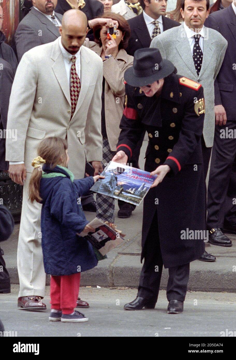 american-pop-star-michael-jackson-r-gives-a-copy-of-his-new-album-to-an-unidentified-young-girl-as-he-leaves-the-grevin-museum-april-19-jackson-inaugurated-his-wax-double-executed-from-four-picturesthe-singer-offered-some-of-his-clothes-to-dress-the-model-for-the-museum-where-world-celebrities-and-french-historical-scenes-are-represented-2D5DA74.jpg