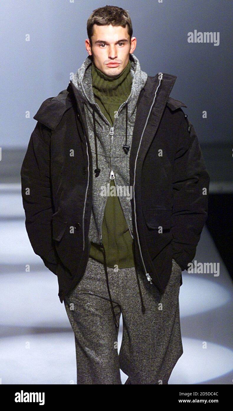 A model for Belgian designer Olivier Strelli presents this black zipped  jacket over grey hooded top anf green jumper with grey trousers as part of  his Autumn/Winter 1999 Men's fashion collection, January