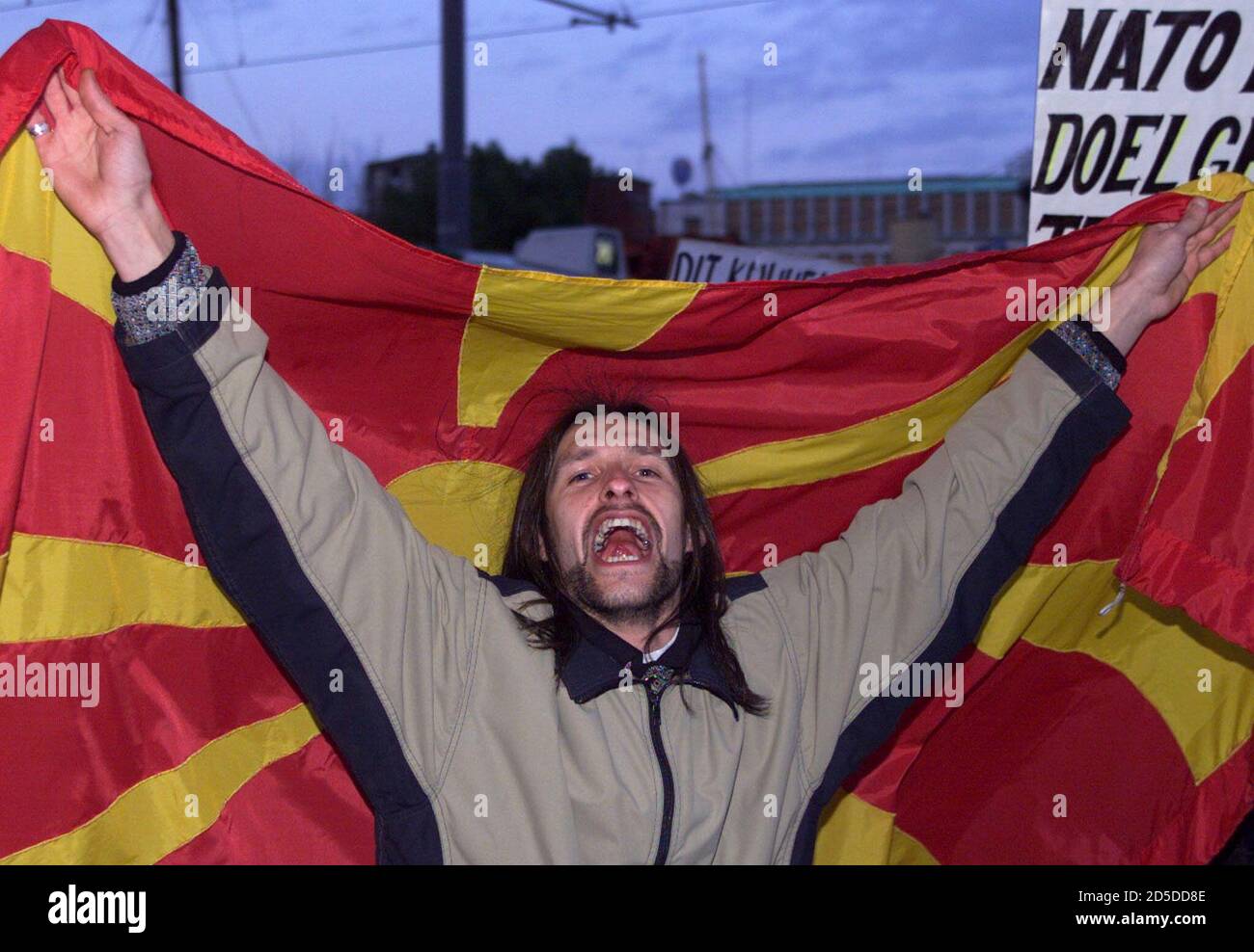 A Dutch Macedonian man with a Macedonian flag shouts anti-NATO slogans during a peaceful protest in Rotterdam April 22. Yugoslav Macedonians, Croats, Serbs and Gypsies protested against the bombing of their mother country Yugoslavia by NATO air power.  FEE/CLH/ Stock Photo