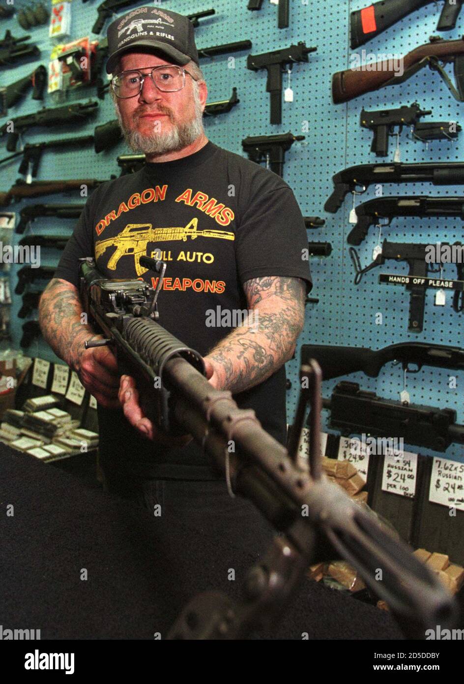Gun dealer Mel Bernstein holds an M-60 machine gun in his gun shop outside  Colorado Springs April 27. Bernstein alerted federal authorities that  school shooting suspects Dylan Klebold and Eric Harris, along
