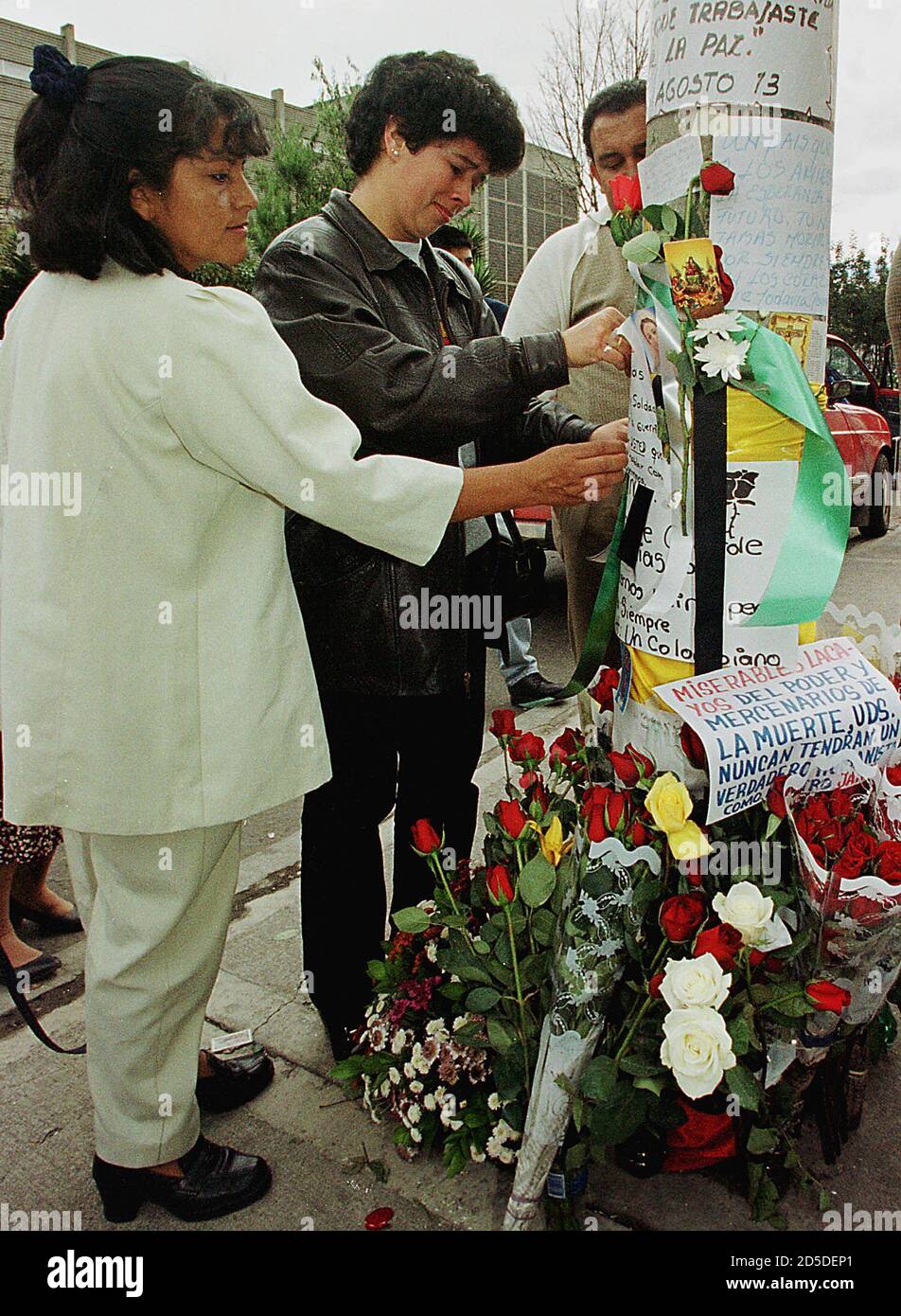 Two Colombian Women Admirers Cry As They Put Flowers At The Spot Where Colombian Comic Jaime Garzon Was Murdered By Unidentified Gunmen On His Way To Work In Bogota August 13 The
