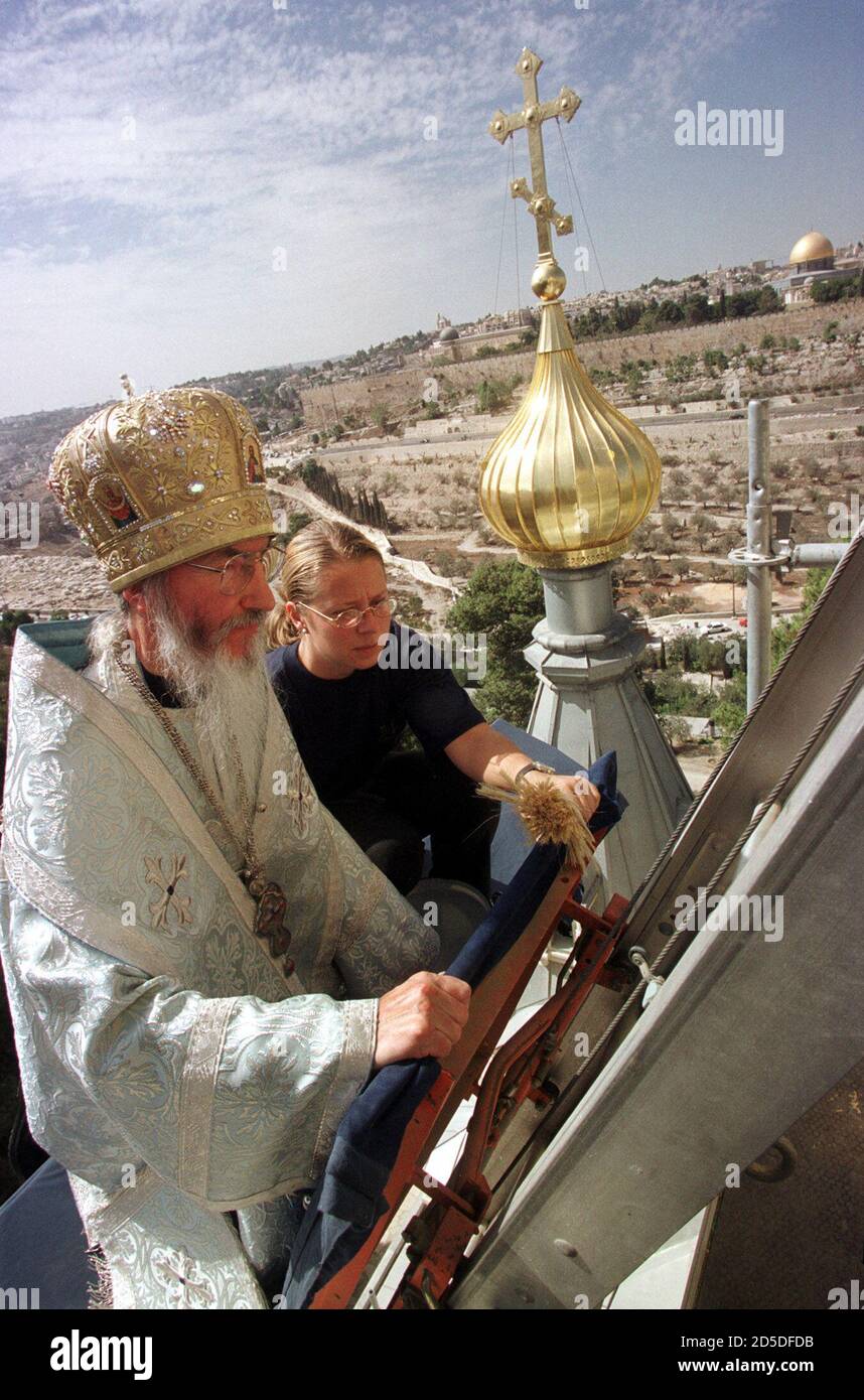 Russian Orthodox Archbishop Mark, overseer of Holy Land properties for the Russian Orthodox Church, arrives to the top Saint Mary Magdalene church by a special electric ladder October 14. The restoration of the domes and the interior of the church took three years and cost $1.5 million to put the church back into a state that is safe for tourists expected to take part in Millennium events in Jerusalem. The church is next to the Garden of Gethsemane, sacred to Christians as the place where Jesus spent the night before his crucifixion. The church was built in 1887 under Russian Czar Alexander II Stock Photo