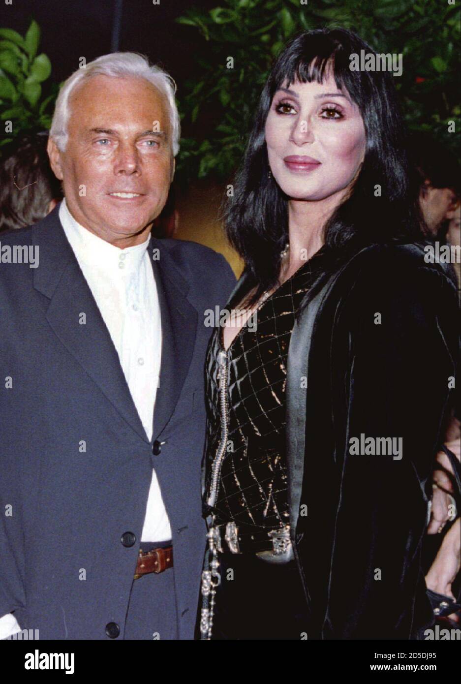 Fashion designer Giorgio Armani (L) poses for photographers with actress Cher before the a fashion show and dinner February 4 in New York. The show featured Armani's spring and summer