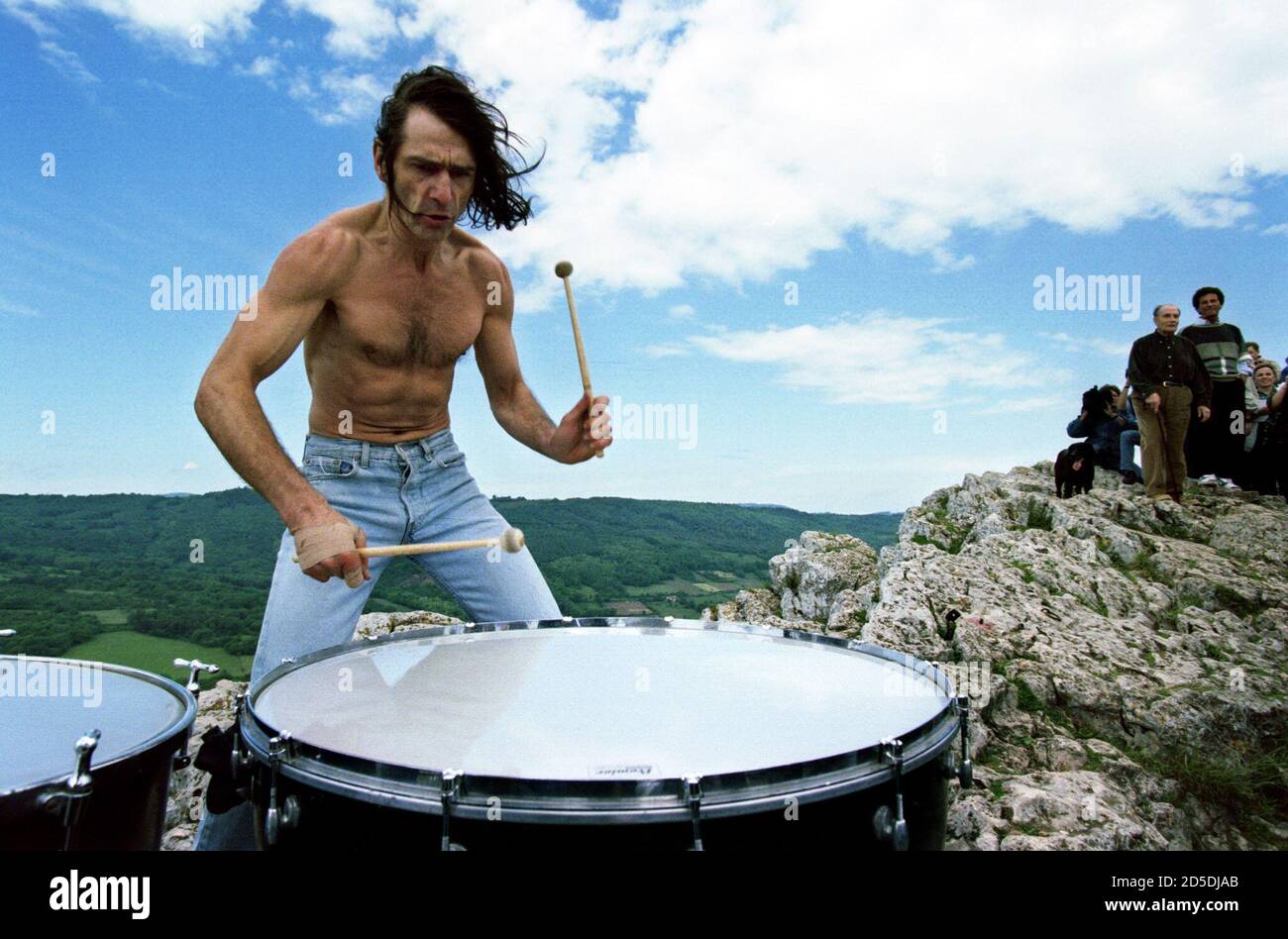 Don Jean Habrey plays drums on the top of the rock of Solutre, center of  France, as France's President of the Republique Francois Mitterrand (r)  climbs this hill as every year during