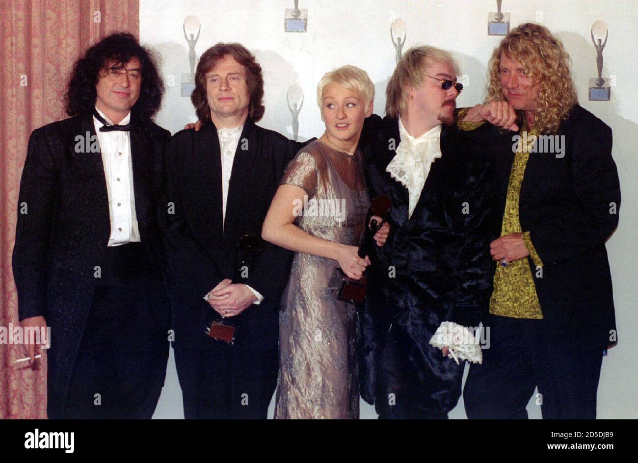 Members of the rock band Led Zeppelin, from left, Jimmy Page, John Paul Jones and Robert Plant (far right) pose with Jason and Zoe Bonham, the children of late band member John Bonham, (center right) after the band was inducted into the Rock and Roll Hall of Fame in New York January 13 Stock Photo