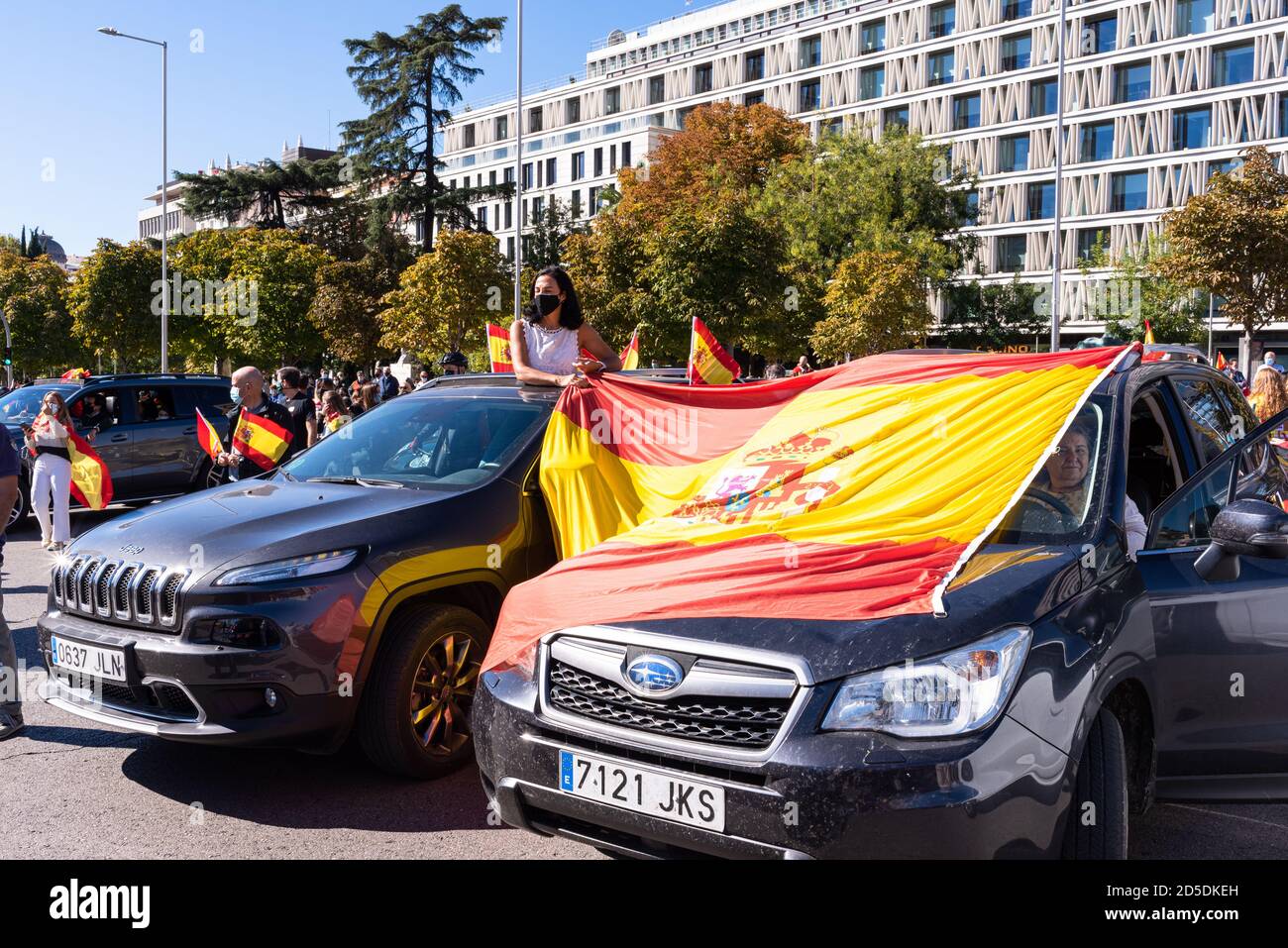 Madrid, Spain, 12th oct 2020. Woman holding flag as she attends a car parade protest against Spanish government's handling of the COVID-19 crisis. Stock Photo