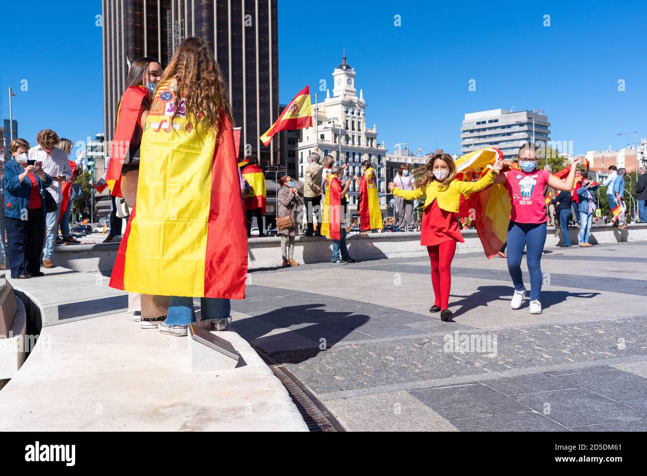 Madrid, Spain, 12th oct 2020. Children dancing with flags during a protest against Spanish government's handling of the COVID-19 crisis. Stock Photo