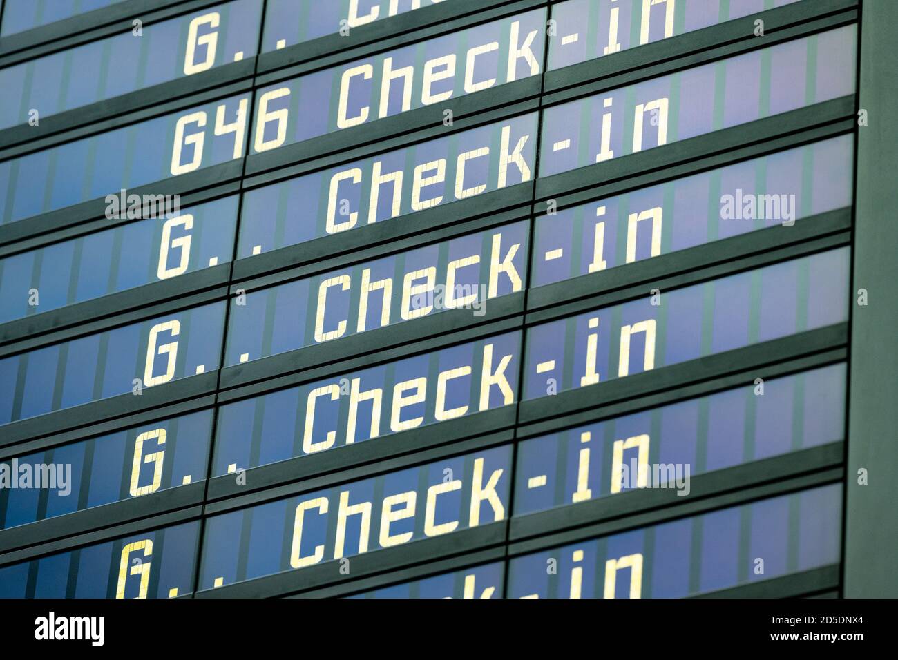 Digital Display in the airport shows 'Check-in' in many lines one below the other. Stock Photo