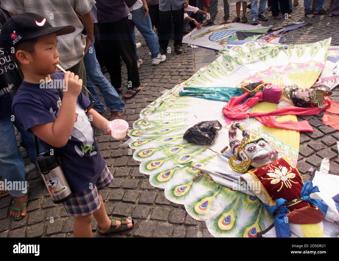 An Indonesian boy looks at traditional kites from West Javaduring an Jakarta International Kite Festival in Jakarta July 18. Jakarta is holding a two-day kite festival to celebrate the 472nd anniversary of the founding of the city. PRI/DL Stock Photo