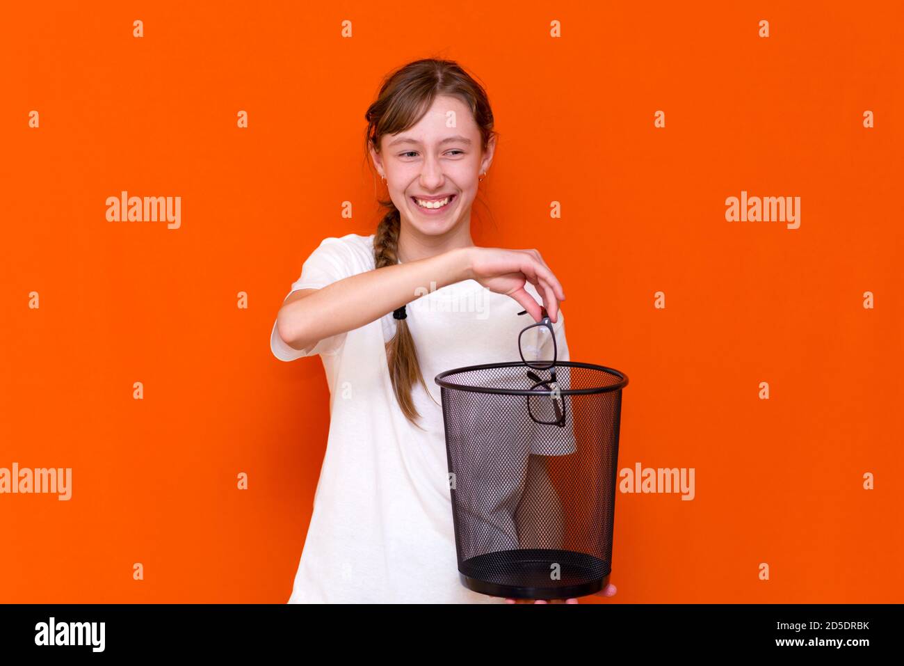 Close up smiling calm serious young girl throw away her glasses in the