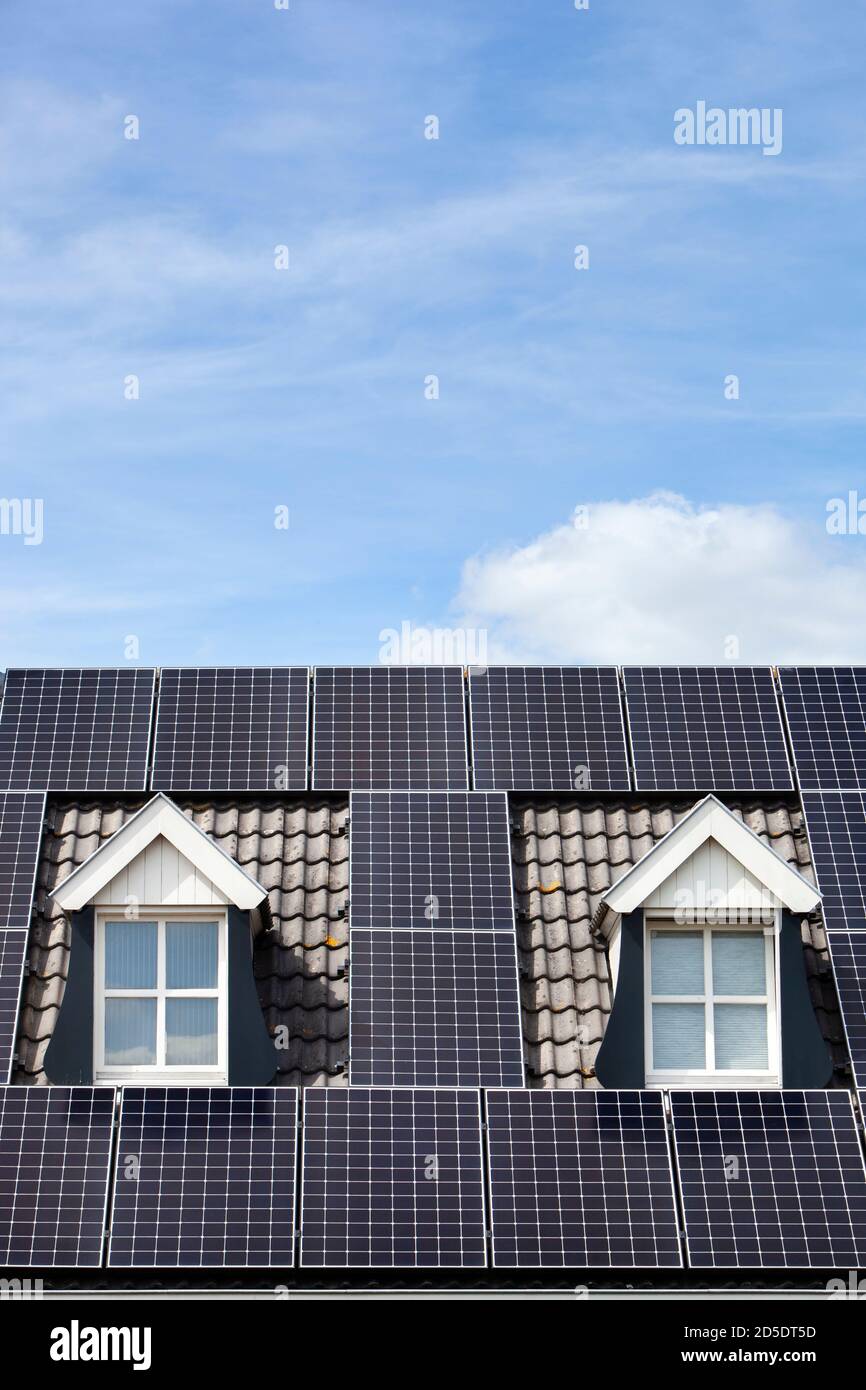 Alternative energy from solar panels on a roof with two dormers Stock Photo Alamy