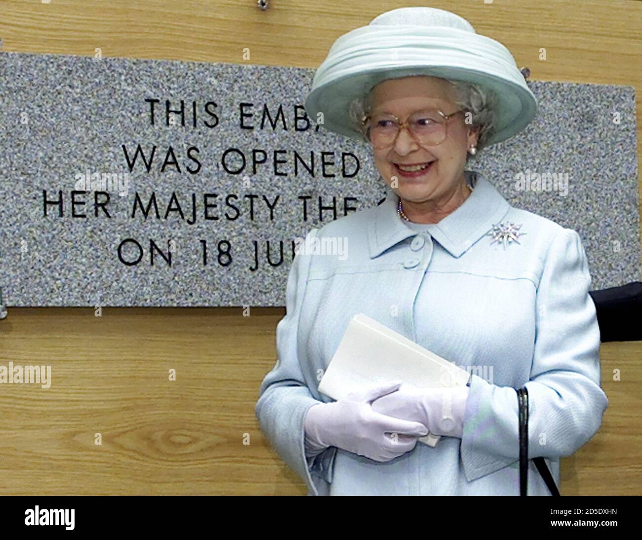 British Queen Elizabeth stands next to a plaque commemorating the opening of the new British embassy during a ceremony in Berlin July 18. The new embassy designed by British architect Michael Wilford is based on the same site as the old building which was destroyed by Allied bombers in World War Two.  MUR Stock Photo