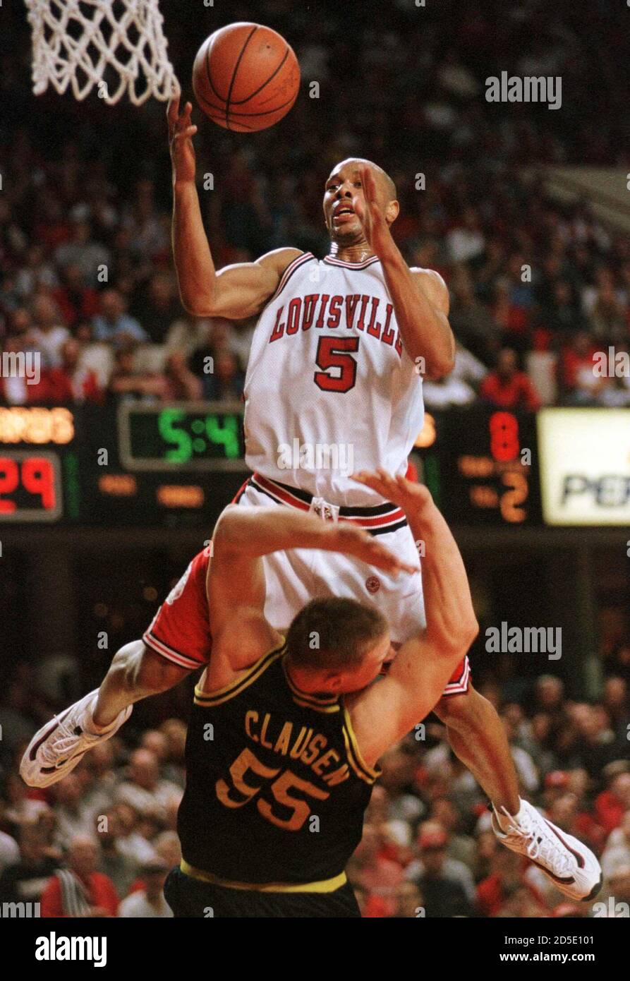 University of Louisville's Marques Maybin goes up and over Marquette's Greg  Clausen as he drives to the basket during the first half of play February 6  at Freedom Hall in Louisville, Kentucky.