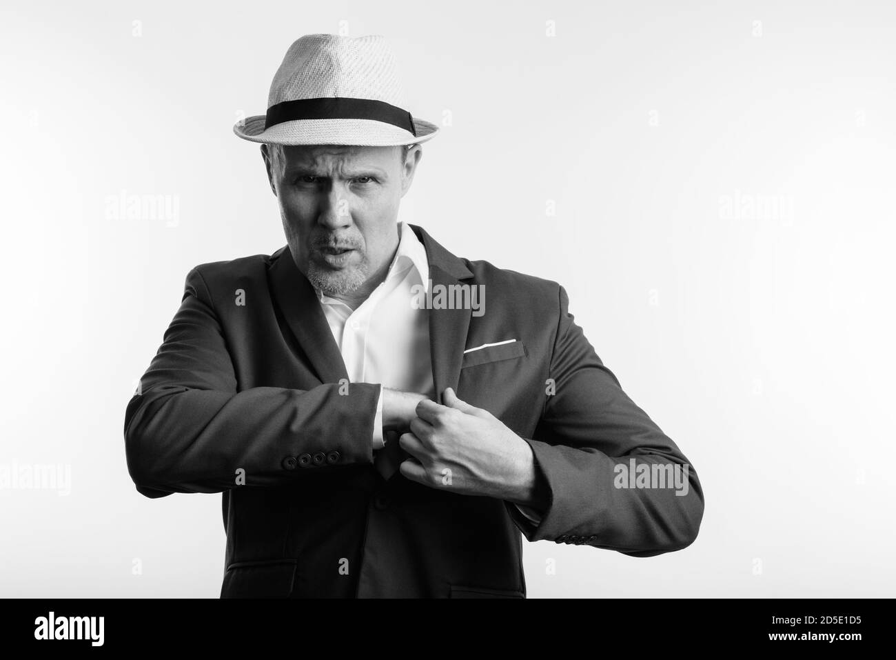 Studio shot of mature businessman with hand on inner pocket Stock Photo