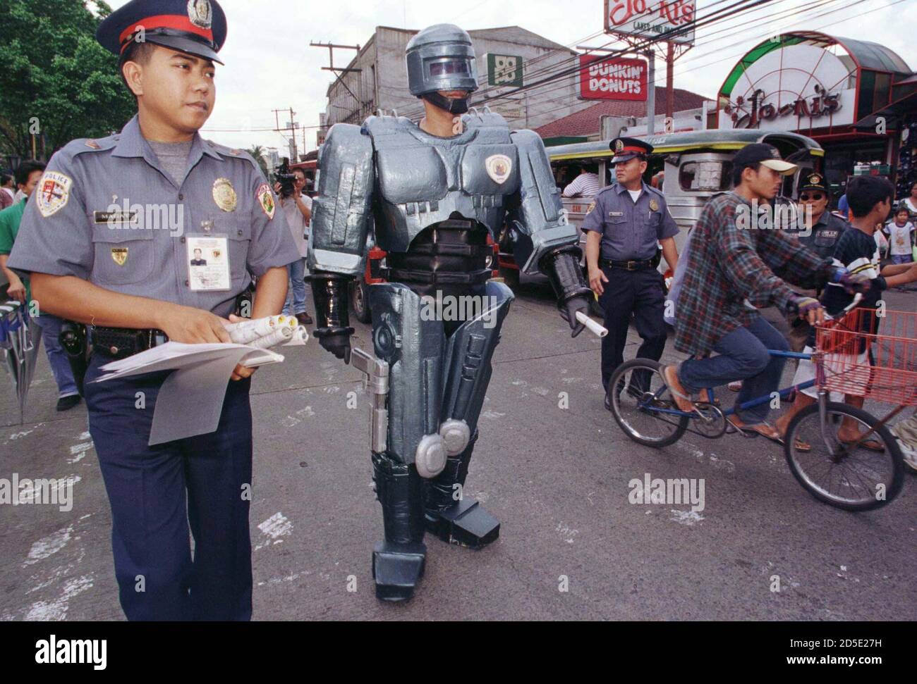 A Filipino policeman dressed up as "Robocop" walks the busy streets of San  Juan in Manila May 12 to promote the government's new anti-drug campaign.  The anti-drug mascot, patterned after the hero