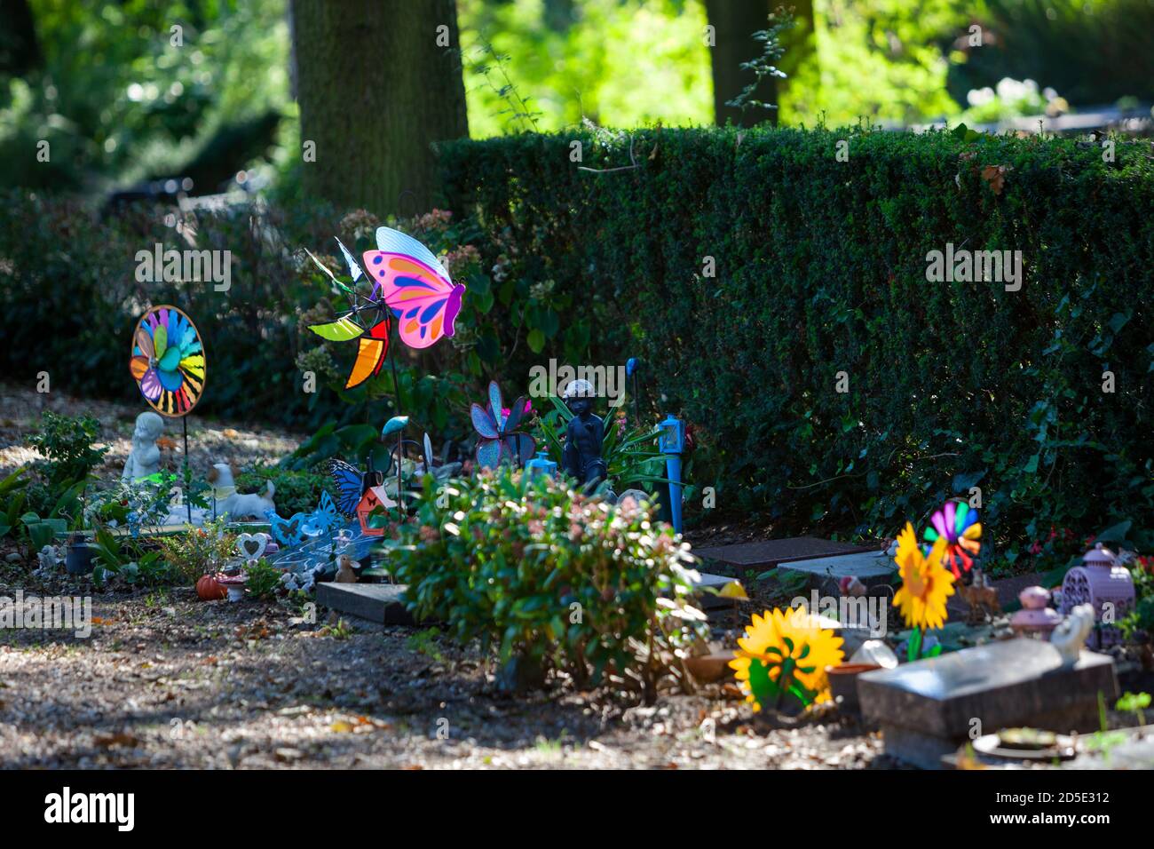 Tombstones and colorful toys on a part of the cemetery for children in Rotterdam in the Netherlands Stock Photo