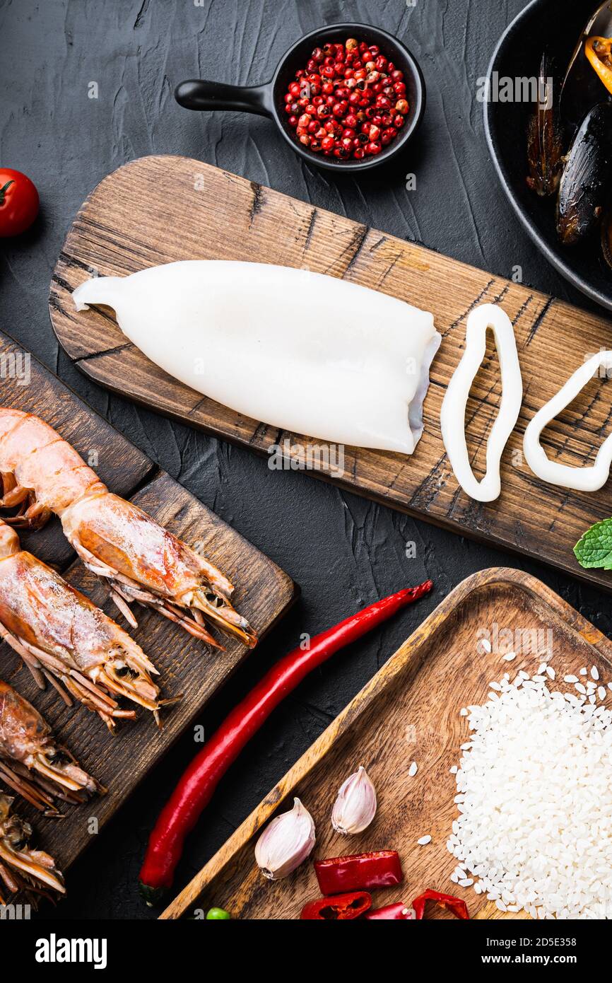 Ingredient for a spanish seafood paella with rice, pea,pepper and