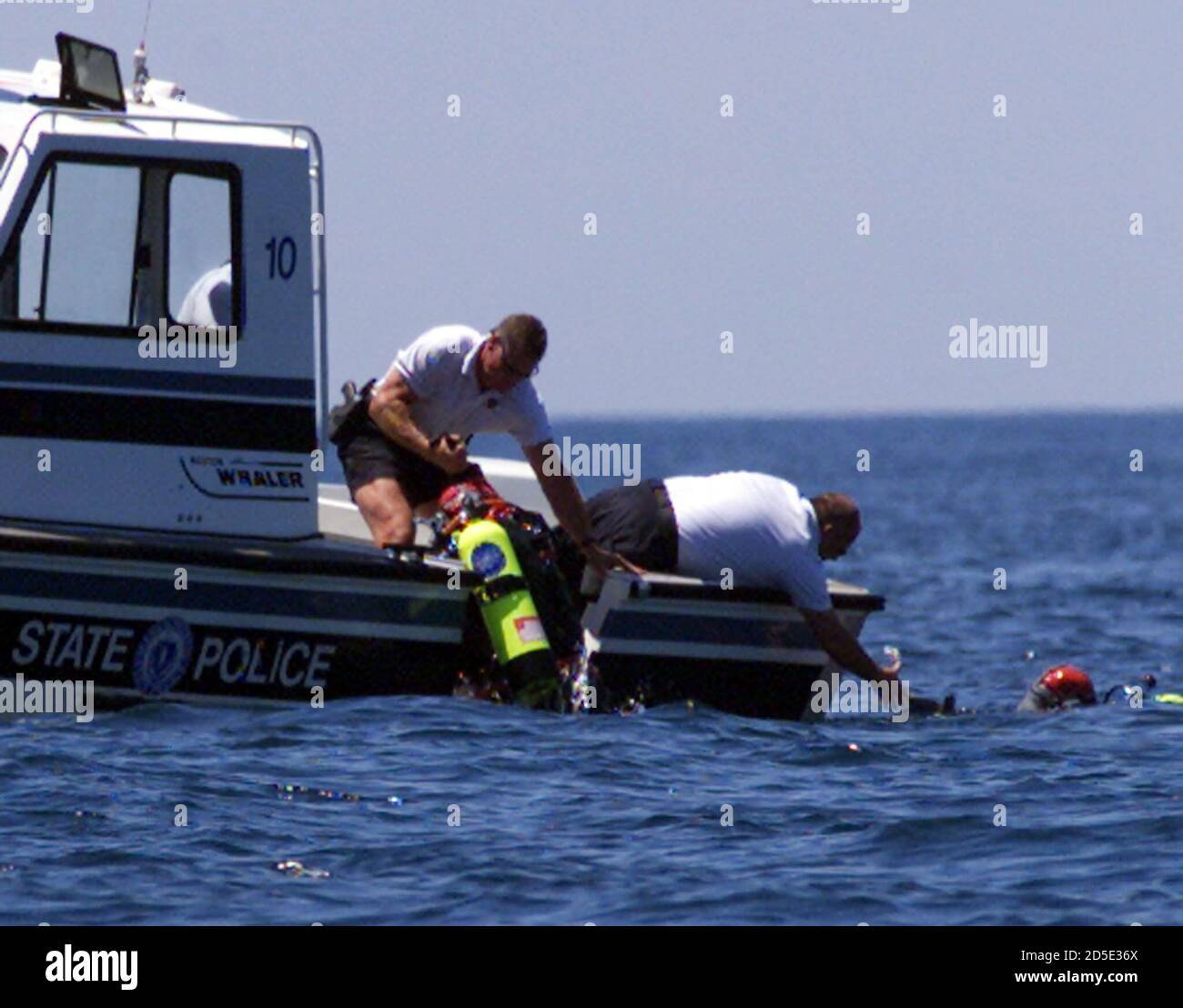 Massachusetts State Police divers from the Underwater Recovery Unit are  helped back into a boat just west of Martha's Vineyard, Massachusetts in  Vineyard Sound, July 20. The dive teams were looking for