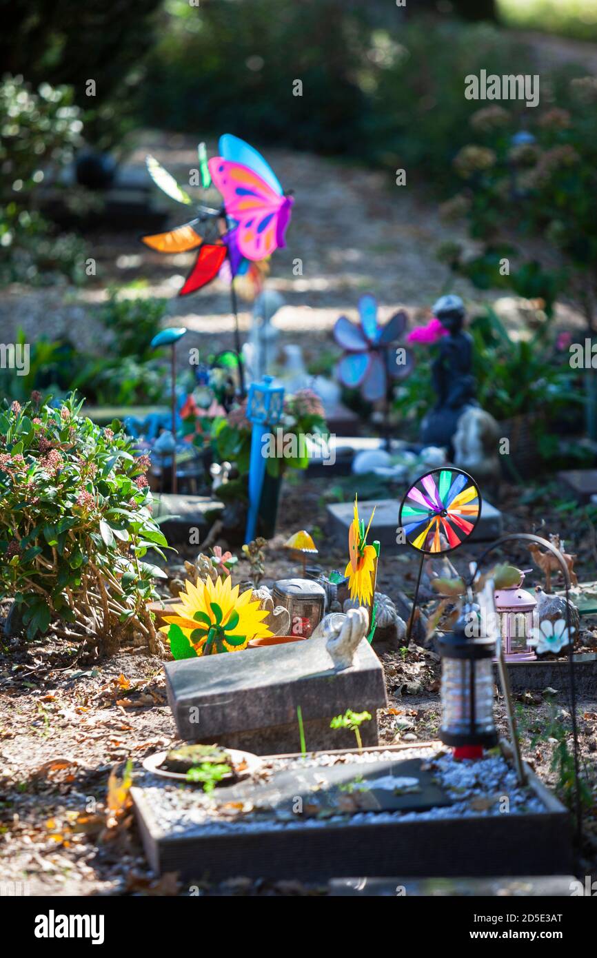Tombstones and colorful toys on a part of the cemetery for children in