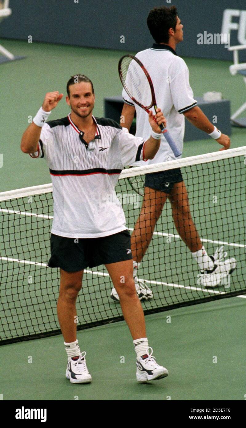 Patrick Rafter of Australia celebrates his win (L) as countrymate Mark  Philippoussis of Australia walks off the court following the U.S. Open  men's final at the USTA National Tennis Center September 13.