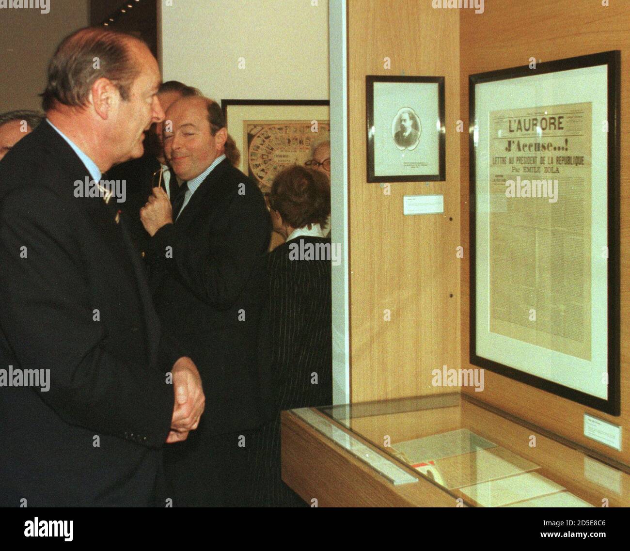 French President Jacques Chirac (L) looks at the the French Newspaper ' L'Aurore' published on January 13 1897 featuring the letter by French writer Emile Zola, with the ' J'Accuse' (I accuse) headline, in defence of the French Jewish army captain Alfred Dreyfus, wrongly accused of treason, as he inaugurates the new 'Museum of Judaism' in the heart of the Paris Jewish quarter November 30. The museum which has a collection of paintings, photographs and artifacts will open its doors to the public on December 6.  GW//AA Stock Photo