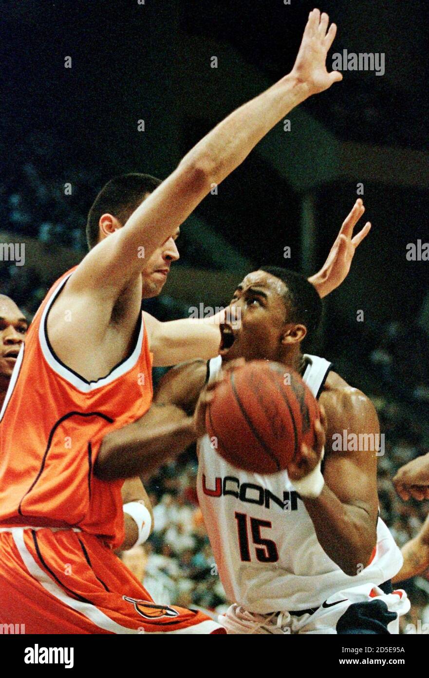 Kevin Freeman (R), one of the top season scoring leaders for the nationally  top-ranked University of Connecticut Huskies, finds himself shut down in  the lane by Elvir Ovcina (L) of the Syracuse