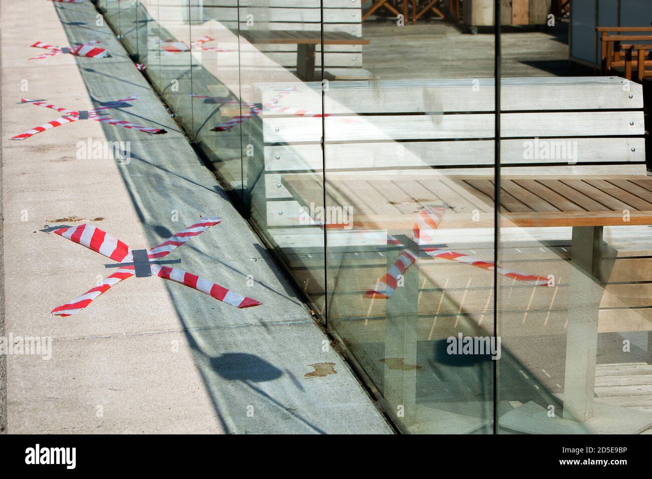 Barrier tape around the empty terraces in Rotterdam during lockdown because of the coronavirus pandemic Stock Photo