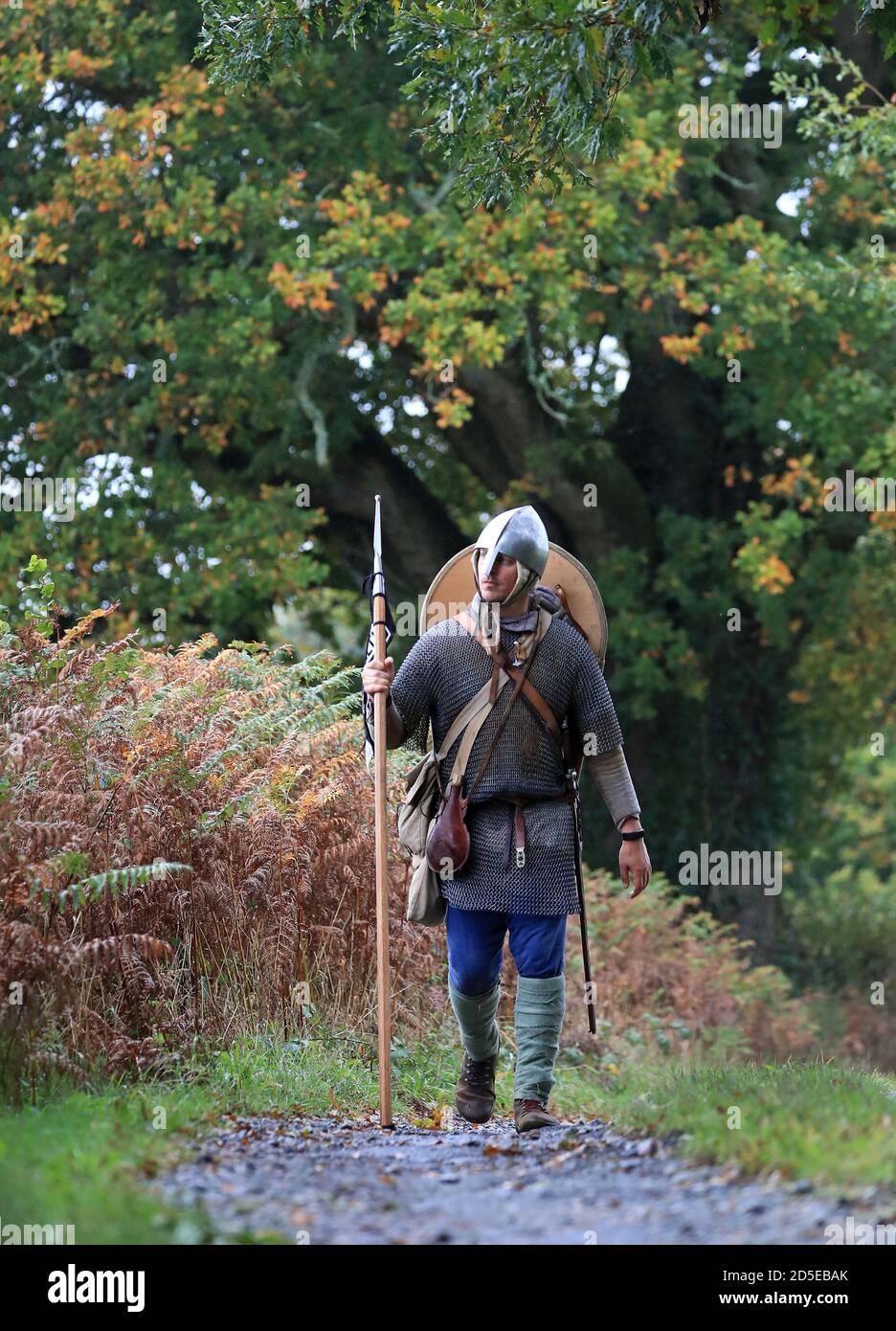 Lewis Kirkbride walks through Wadhurst, East Sussex, on the final day of his 1066 Battle Walk, a 300-mile walk dressed in Anglo Saxon armour weighing four stone, to raise funds for men's mental health peer support organisation ManHealth. Lewis, from Durham, has walked from York to Hastings has taken days and raised over £17,000. Stock Photo