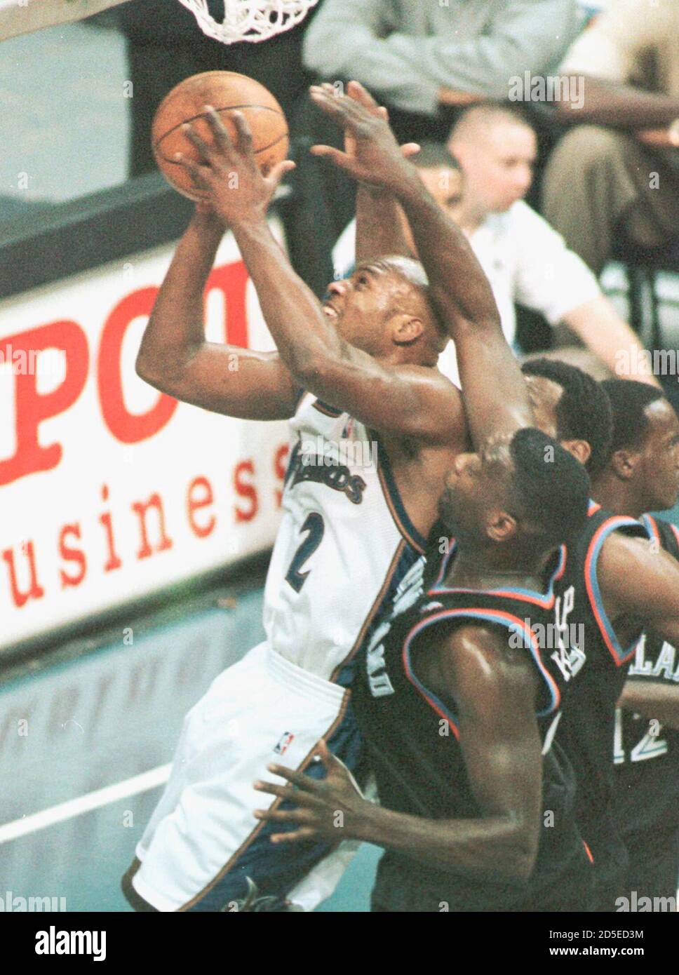 Washington Wizards' Mitch Richmond (2) drives between Cleveland Cavaliers'  Shawn Kemp (foreground) and Lamond Murray enroute to a layup in the first  quarter of their game at the MCI Center December 1.