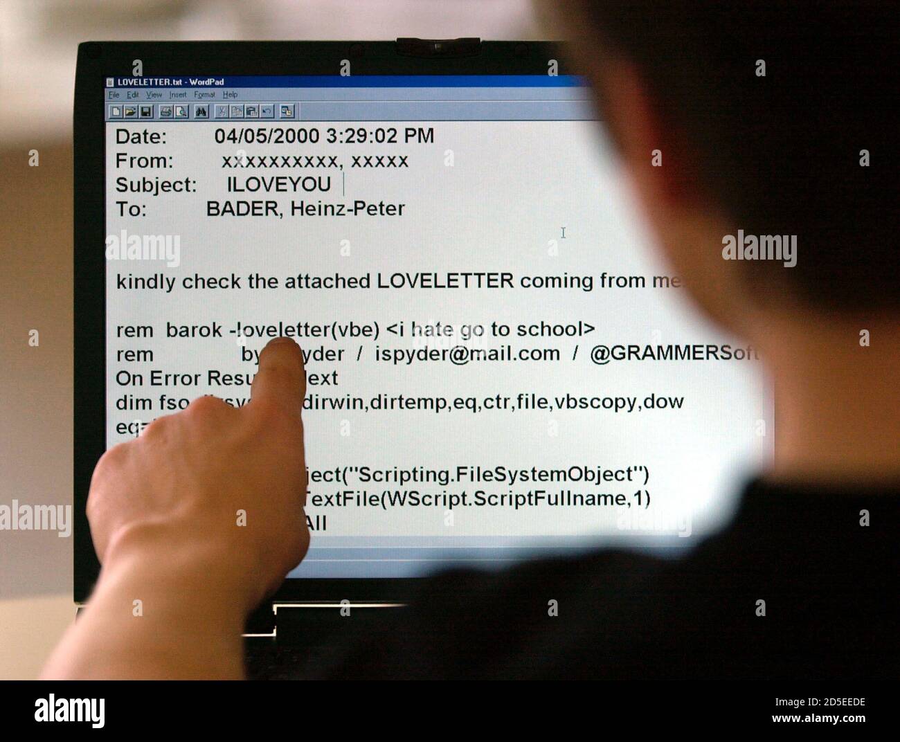 A computer user reads a program code attached to an e-mail dubbed the Love  Bug May 5. The e-mail caused havoc with computer systems worldwide on May  4, shutting down e-mail servers