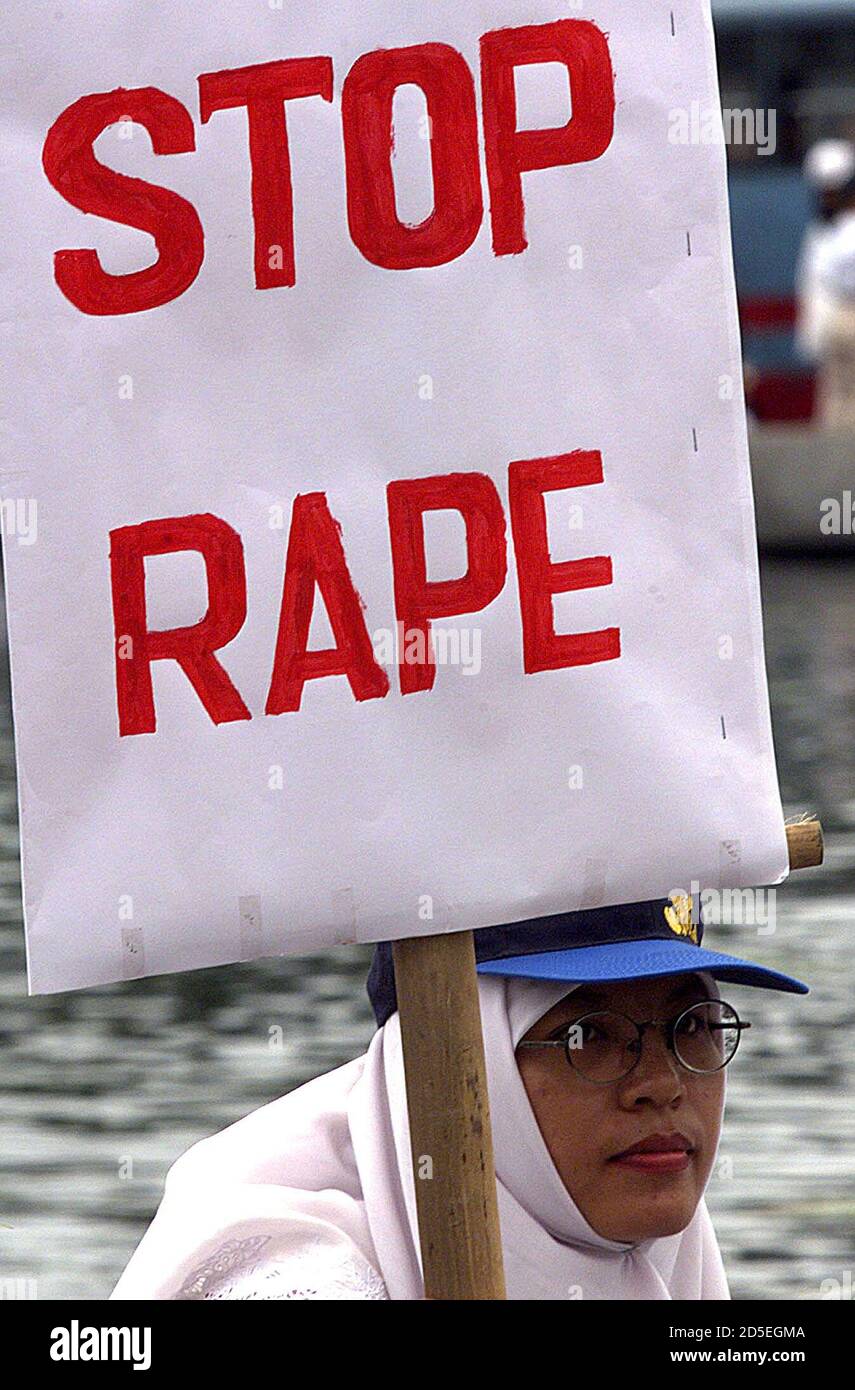 An Indonesian woman holds a placard denouncing rapes in her country during a demonstration in central Jakarta November 25.[ Most Indonesians want to dump their deeply unpopular president, B.J. Habibie, according to a rare opinion poll published on Wednesday amid fresh anti-government protests in the capital.  ] ??» Stock Photo