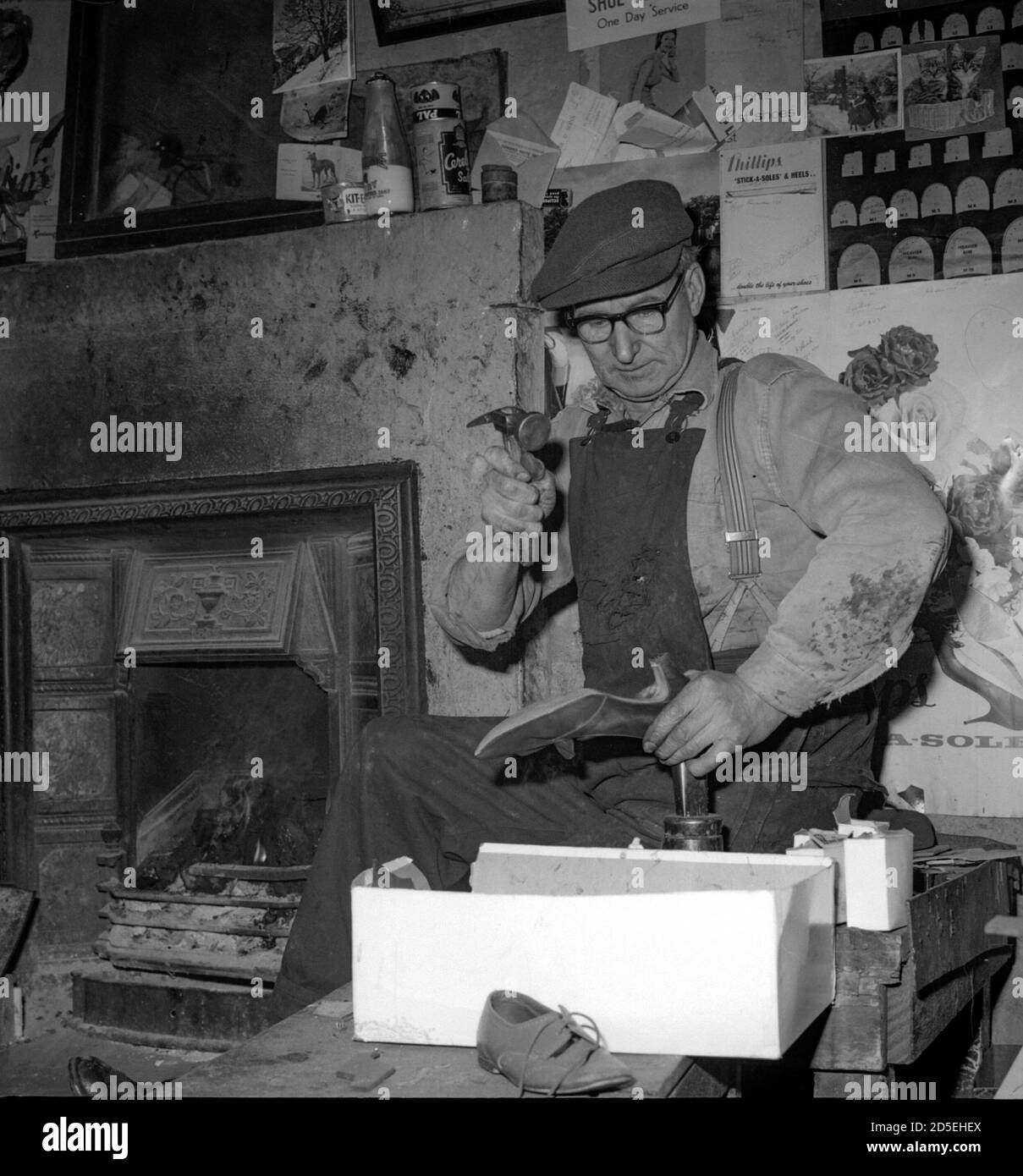 A traditional cobbler and shoemaker at work in his shop in Fife in