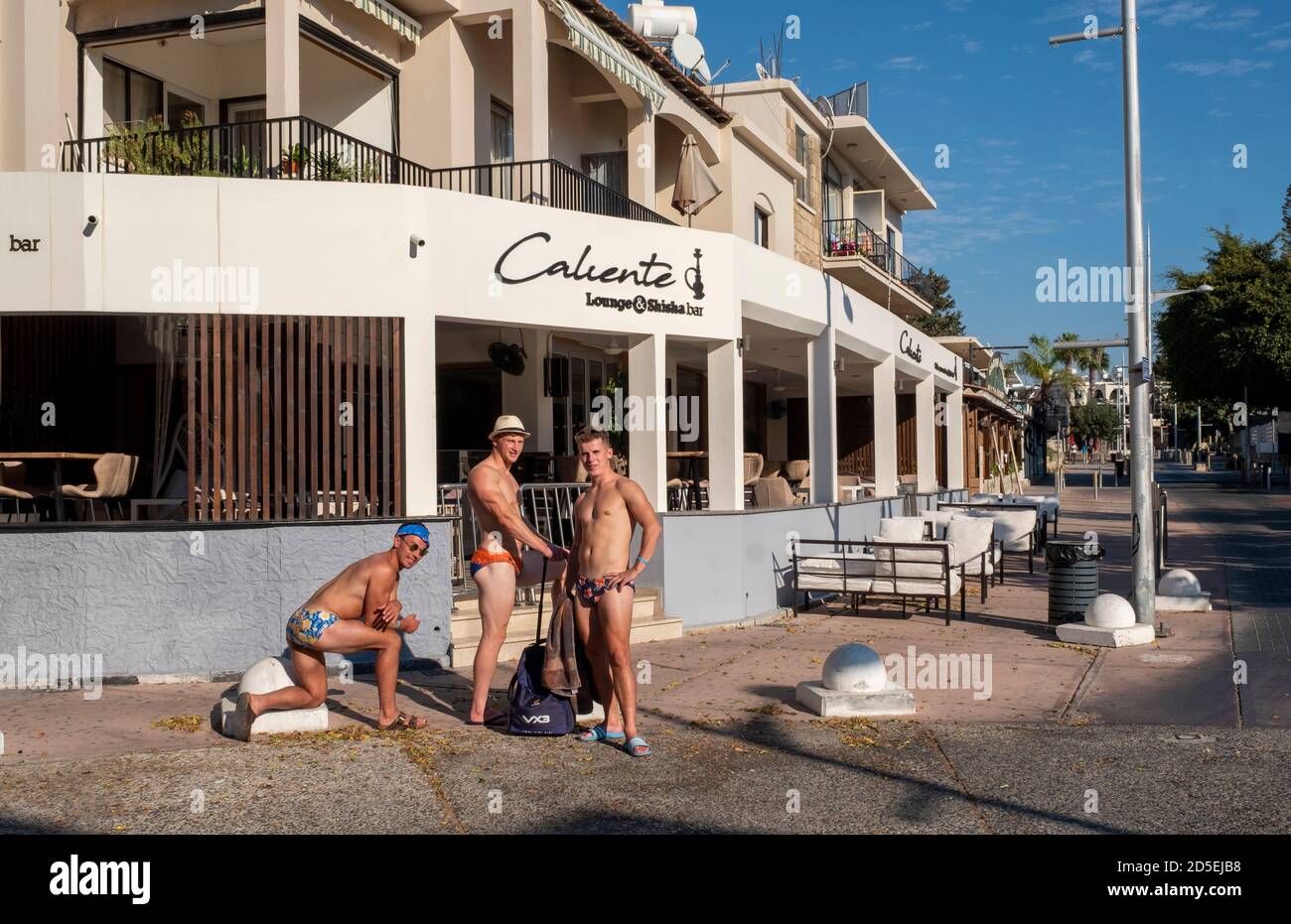 Paphos, Cyprus. 13th Oct 2020. Three British tourists pose for pictures on Bar Street in the deserted tourist area of Kato Paphos during the Coronavirus Pandemic.  Bar Street, Paphos, Cyprus. 13th October, 2020.    Credit: Ian Rutherford/Alamy Live News. Stock Photo