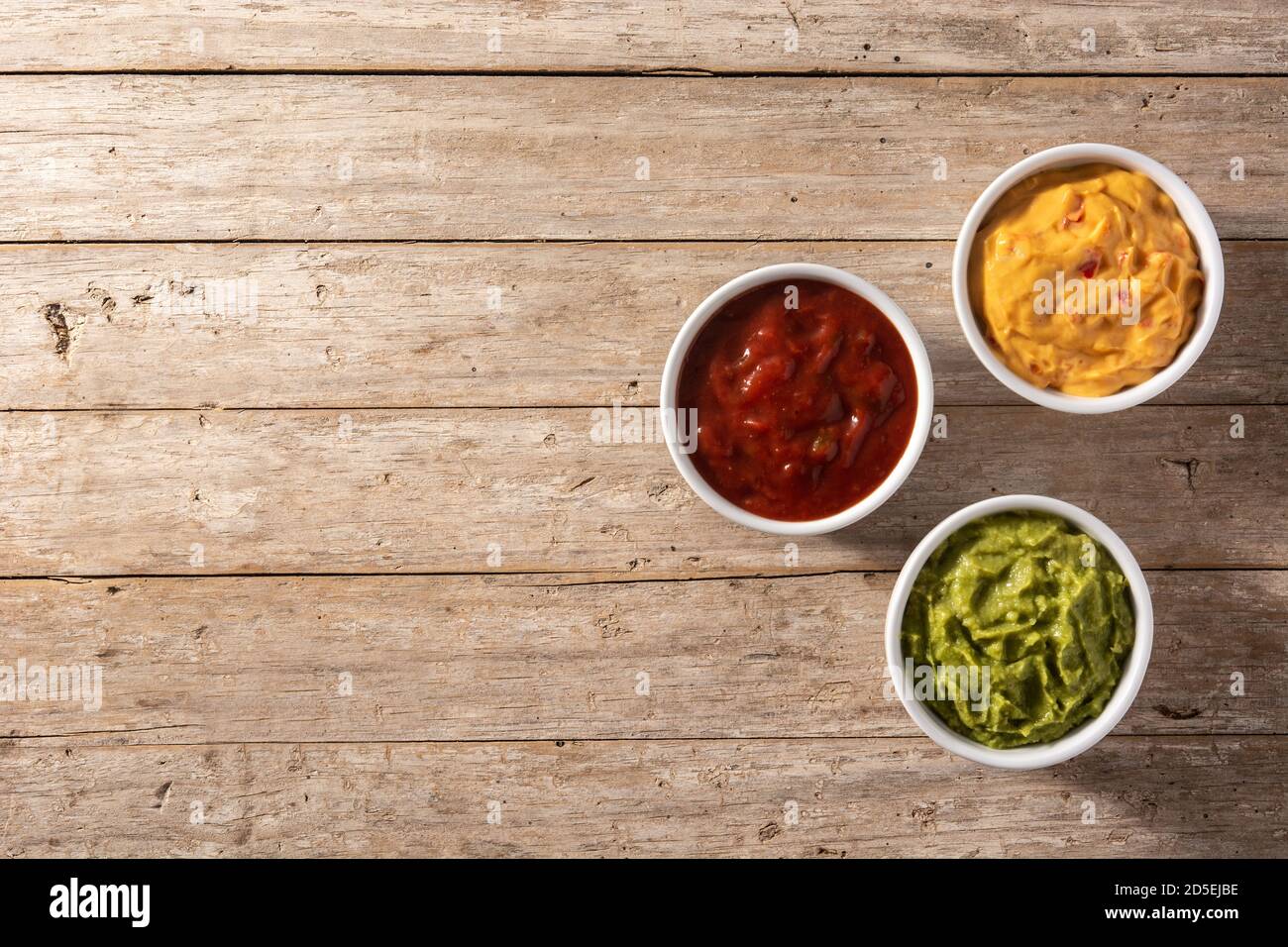 Traditional Mexican sauces. Guacamole, chilli pepper sauce and cheese sauce Stock Photo