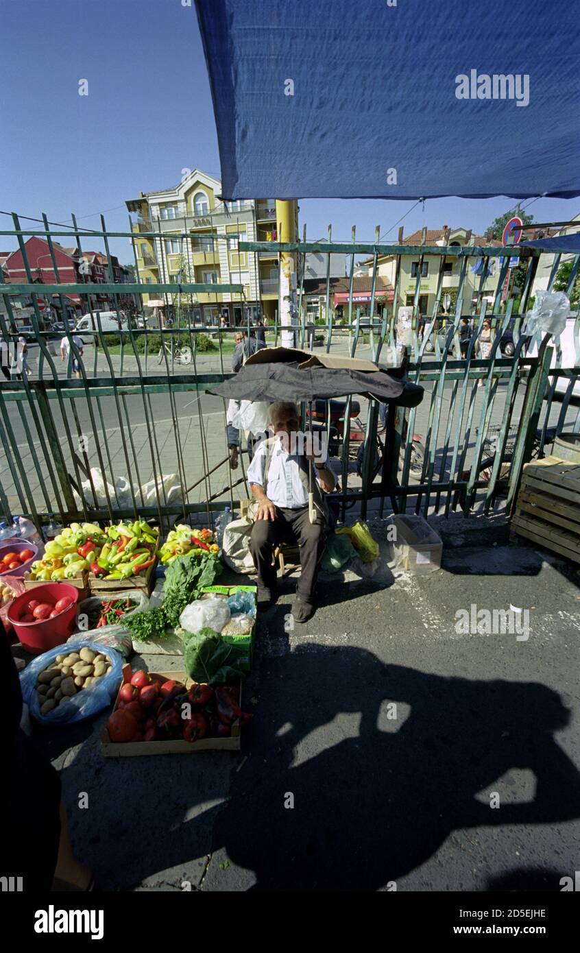 A OLD MAN SELLING VEGETABLES IN THE MARKET OF KRUSEVAC SERBIA - STREET PHOTOGRAPHY - COLOR SILVER FILM © F.BEAUMONT Stock Photo