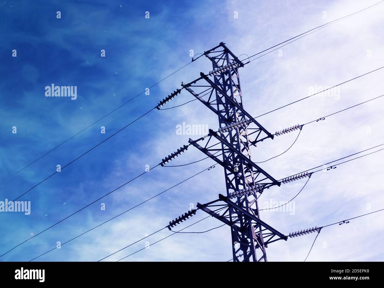 Energy distribution high voltage power line tower with wires Stock Photo