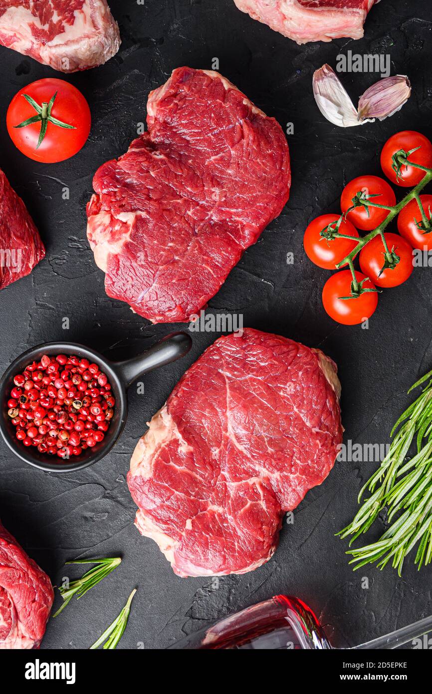 Two rump beef steak cuts, with herbs, seasoning on black table, top view Stock Photo Alamy