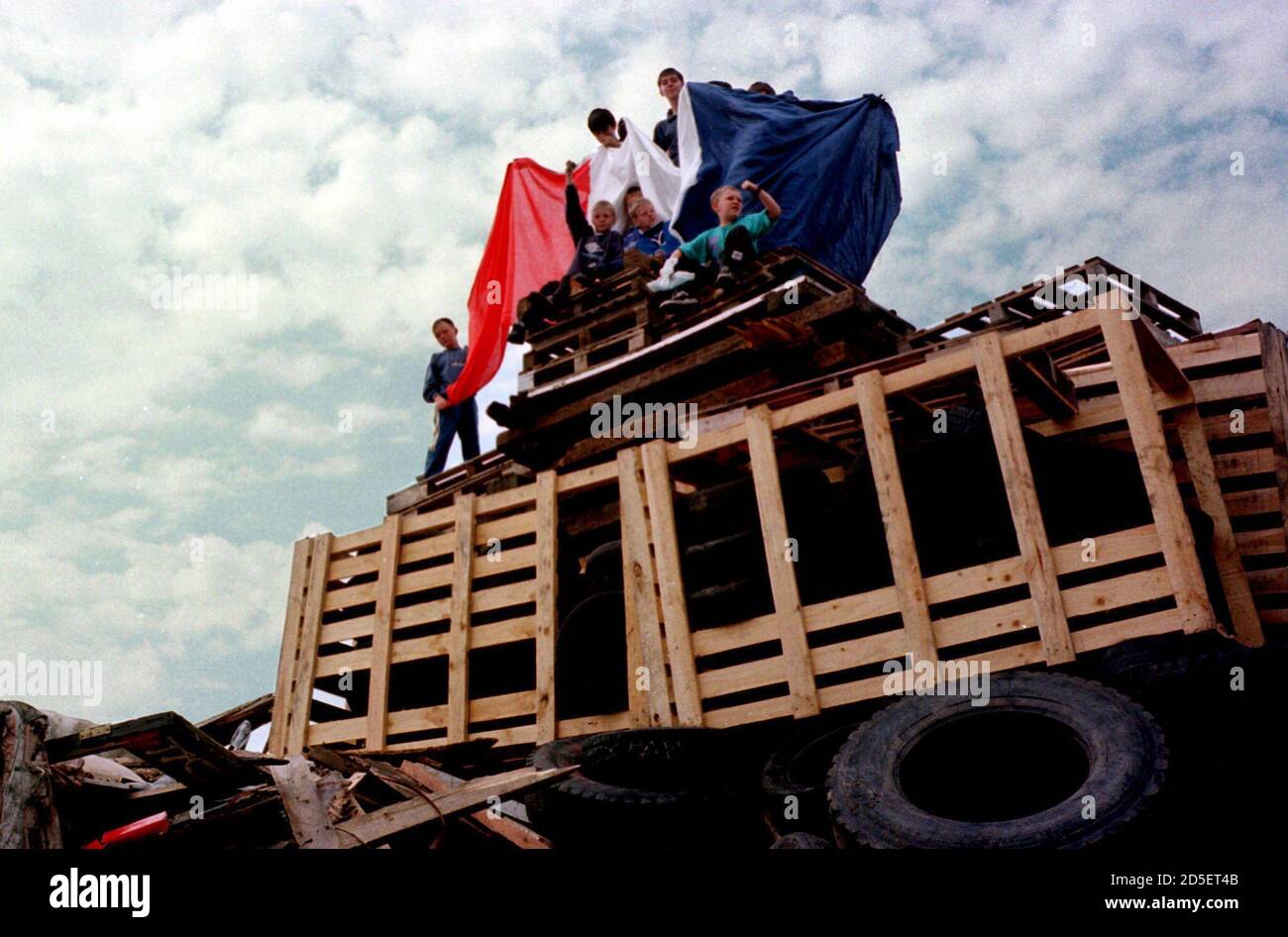 Children from Loyalist areas of Belfast play on a huge unlit bonfire in ...