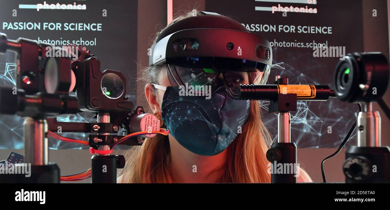 Jena, Germany. 13th Oct, 2020. Canan Gallitzschke observes an optical experimental set-up with AR (augmented reality) glasses during the opening of the 'Digital Teaching Labs' of the Max Planck School of Photonics. Here, in the future, it will be tested how virtual reality, augmented reality and modern media technology can be used to maximize the teaching experience and learning success. Credit: Martin Schutt/dpa-Zentralbild/dpa/Alamy Live News Stock Photo