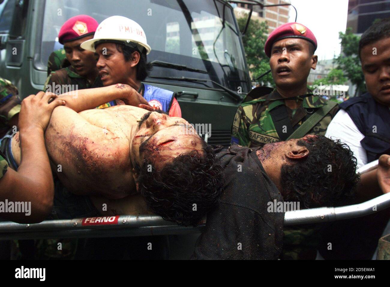 Indonesian Marines load dead bodies onto a truck in central Jakarta November 22. At least four people were killed and troops fired warning shots as a small crowd set fire to a Catholic church in Jakarta's Chinatown. The ethnic clash comes after bloody anti-government protests a week ago that killed at least 14 people. **DIGITAL IMAGE** Stock Photo