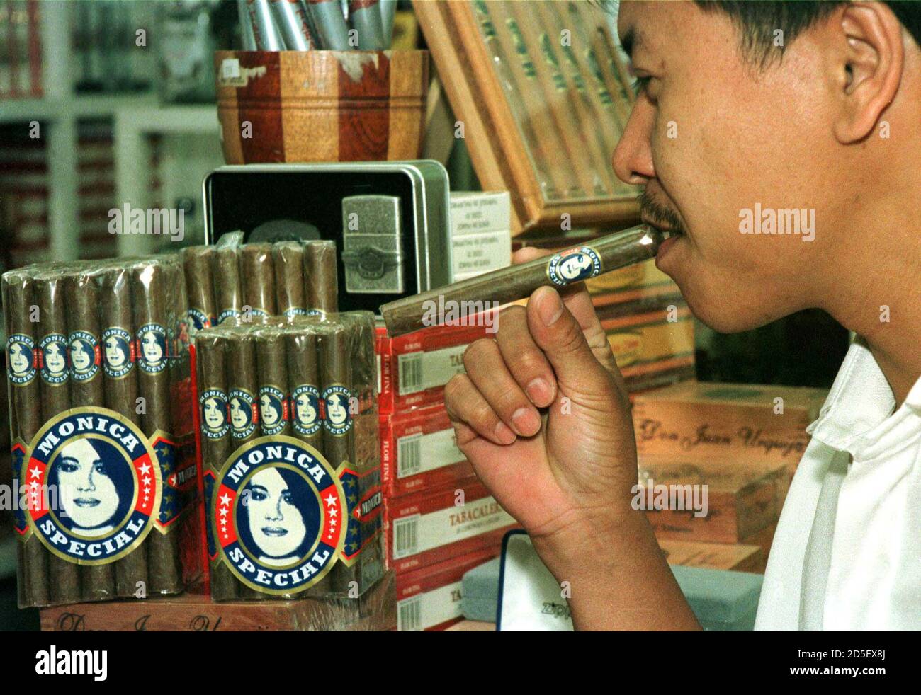 A Filipino Man Tries A New Brand Of Cigars Named The Monica Special After Former White House Intern Monica Lewinsky At A Tobacco Store In Manila February 7 La Flor De La