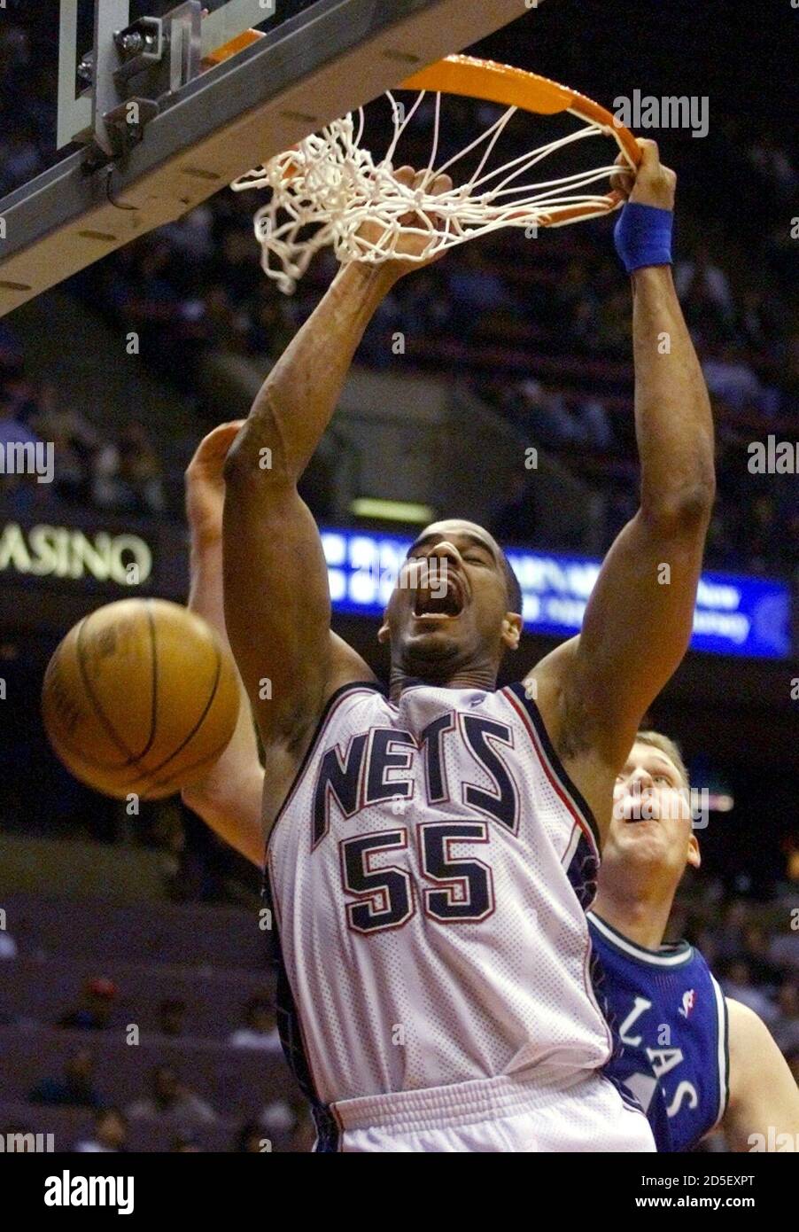 New Jersey Nets center Jayson Williams (55) stuffs the ball in front of  Dallas Mavericks center Shawn Bradley in the fourth period of their NBA  game, March 17 at the Meadowlands Arena
