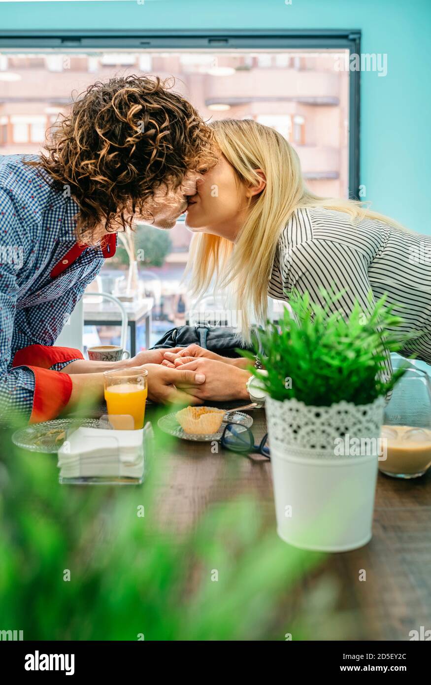 Couple kissing in a cafe Stock Photo