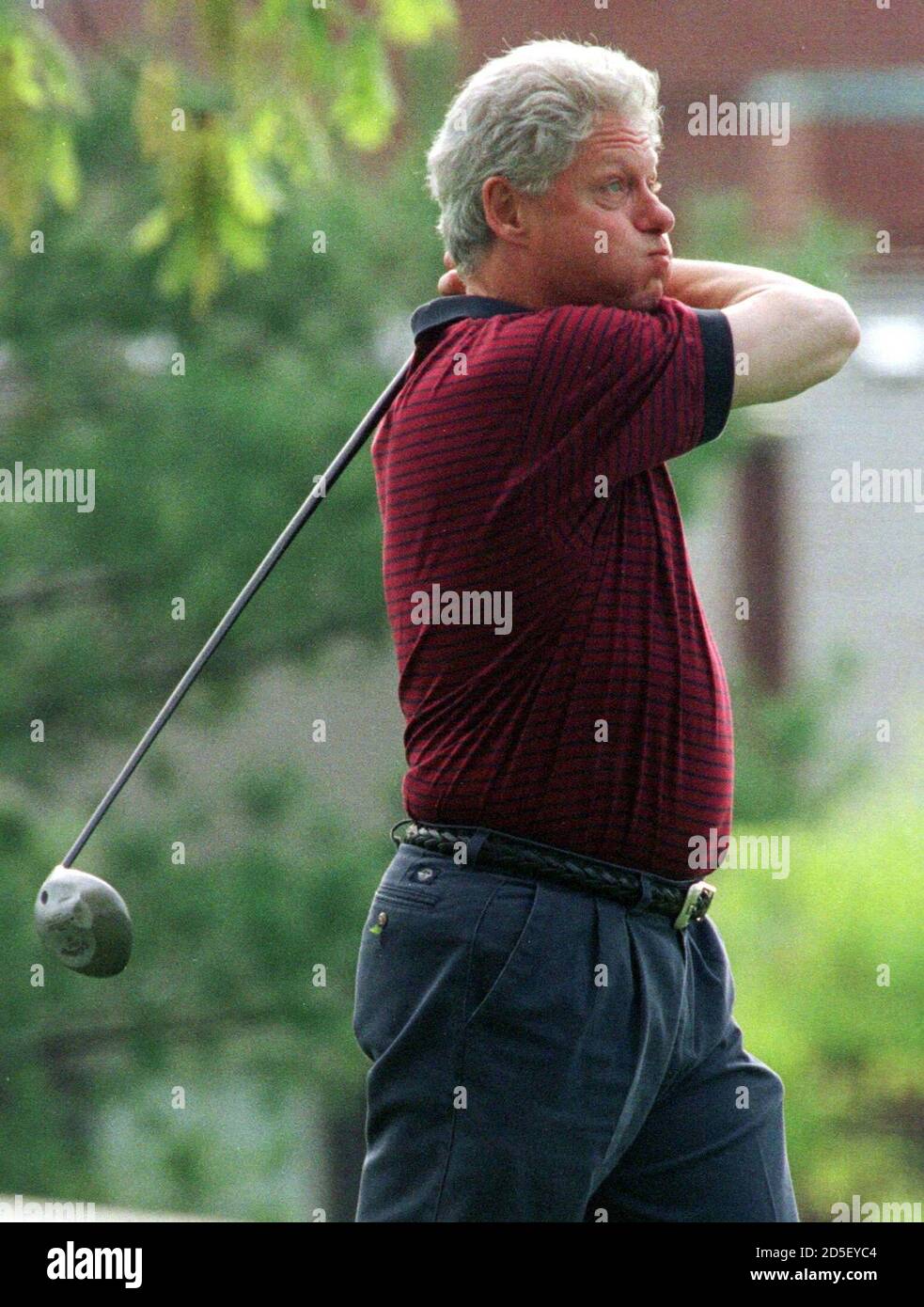 President Bill Clinton watches the flight of his ball as he tees off on the  10th hole during a round of golf at the Army Navy Country Club in  Arlington, April 26.