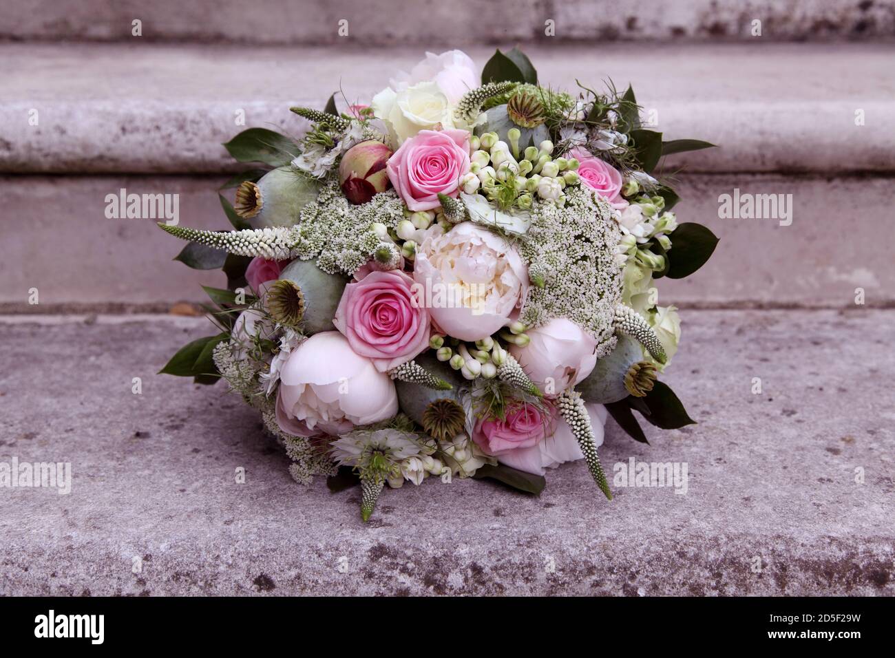 Pastel coloured bridal bouquet of flowers with pink roses, white rose and gypsophila Stock Photo