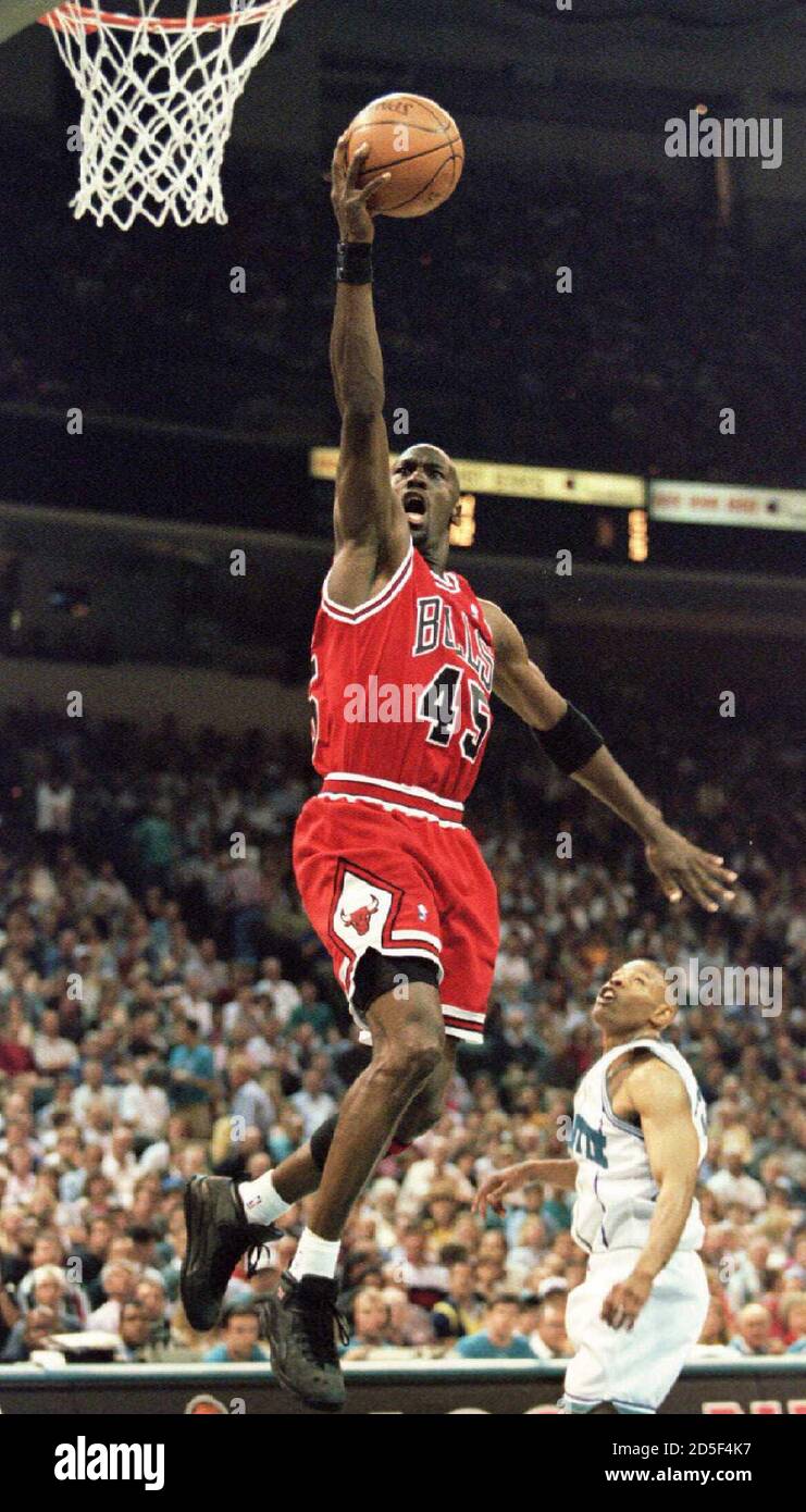 Chicago Bulls' guard Michael Jordan goes up for a basket over Charlotte  Hornets Tyrone Bogues during 2nd quarter action in their first round NBA's  playoff game, April 28, 1995. REUTERS/Gary Hershorn GMH/CMC
